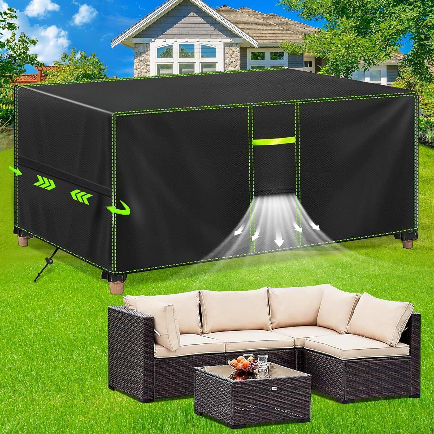 Outdoor-Möbelset mit beigen Kissen steht auf einem Rasen. Im Hintergrund schützt eine große, schwarze rechteckige Abdeckung eine weitere Struktur.