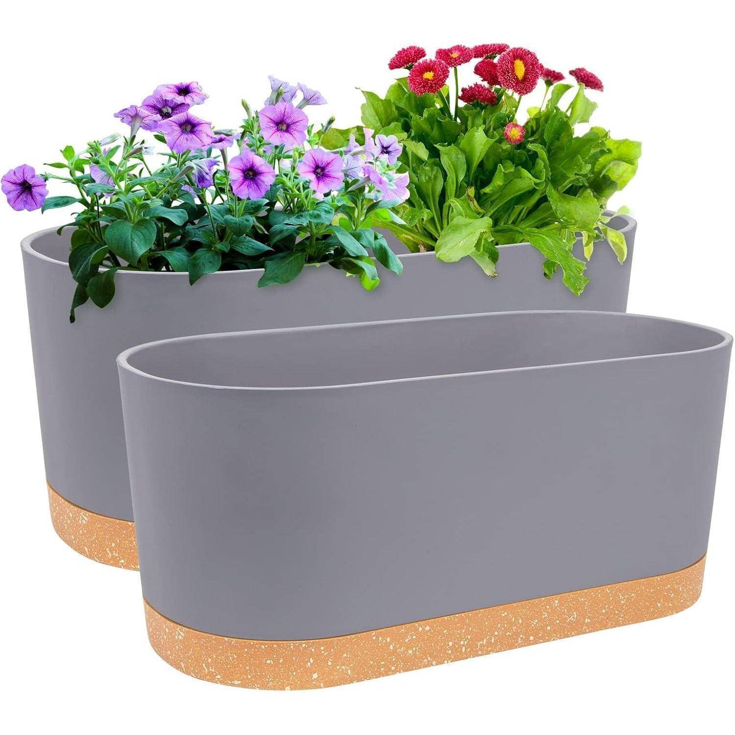 Zwei graue Pflanzgefäße mit gefleckten Sockeln, jedes gefüllt mit blühenden Blumen; eines mit violetten Petunien und das andere mit roten Gänseblümchen.