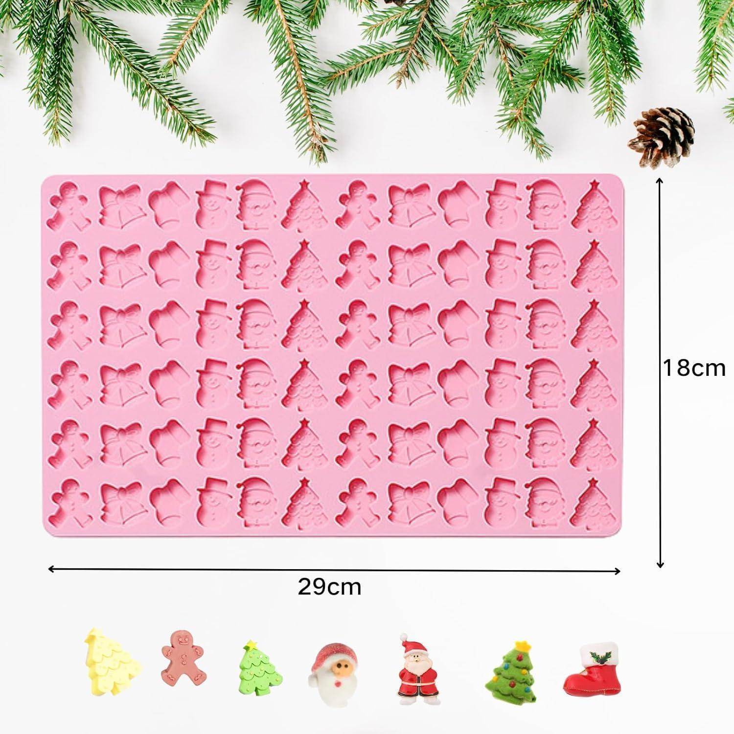 Eine rosa Silikonform mit verschiedenen weihnachtlichen Motiven wie Weihnachtsmann, Schneemänner und Bäumen, die 29 cm x 18 cm misst.