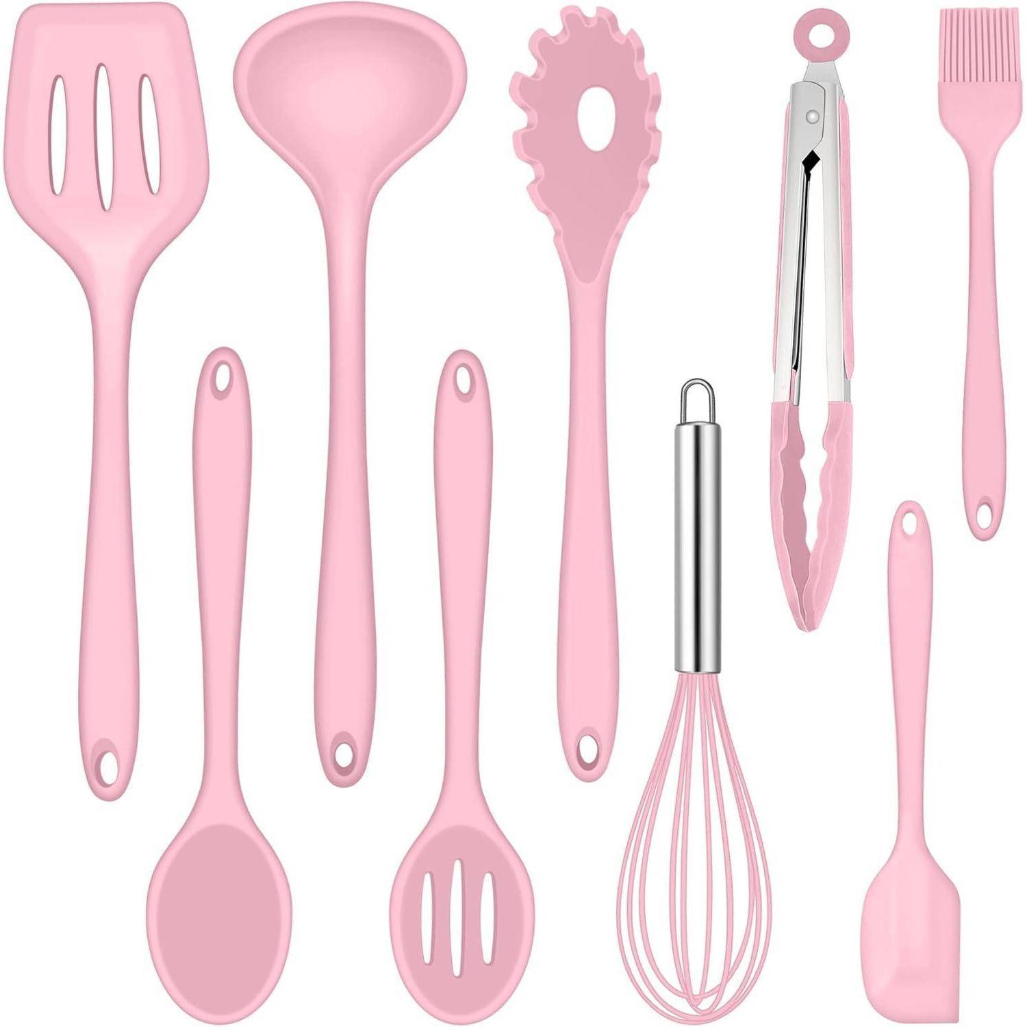 Ein Set rosa Küchenutensilien, bestehend aus Spatelwerkzeugen, Schöpflöffel, Löffel, Schneebesen, Zange und Pinsel, angeordnet auf einem weißen Hintergrund.