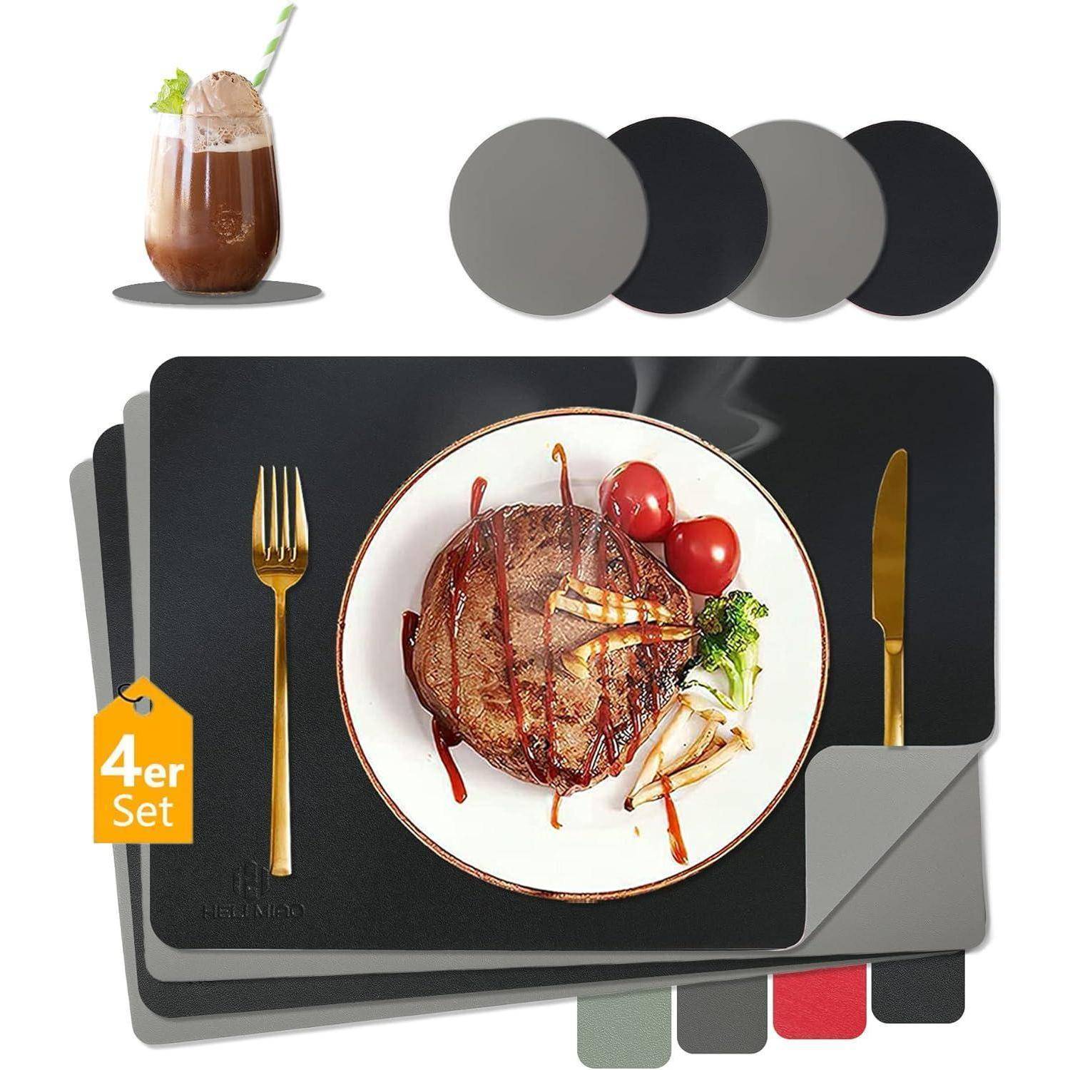 Vierteilige Tischsets in Schwarz und Grau mit einem Steak-Dinner auf einem weißen Teller. Begleitet von einem Kakaogetränk und goldenen Bestecken.