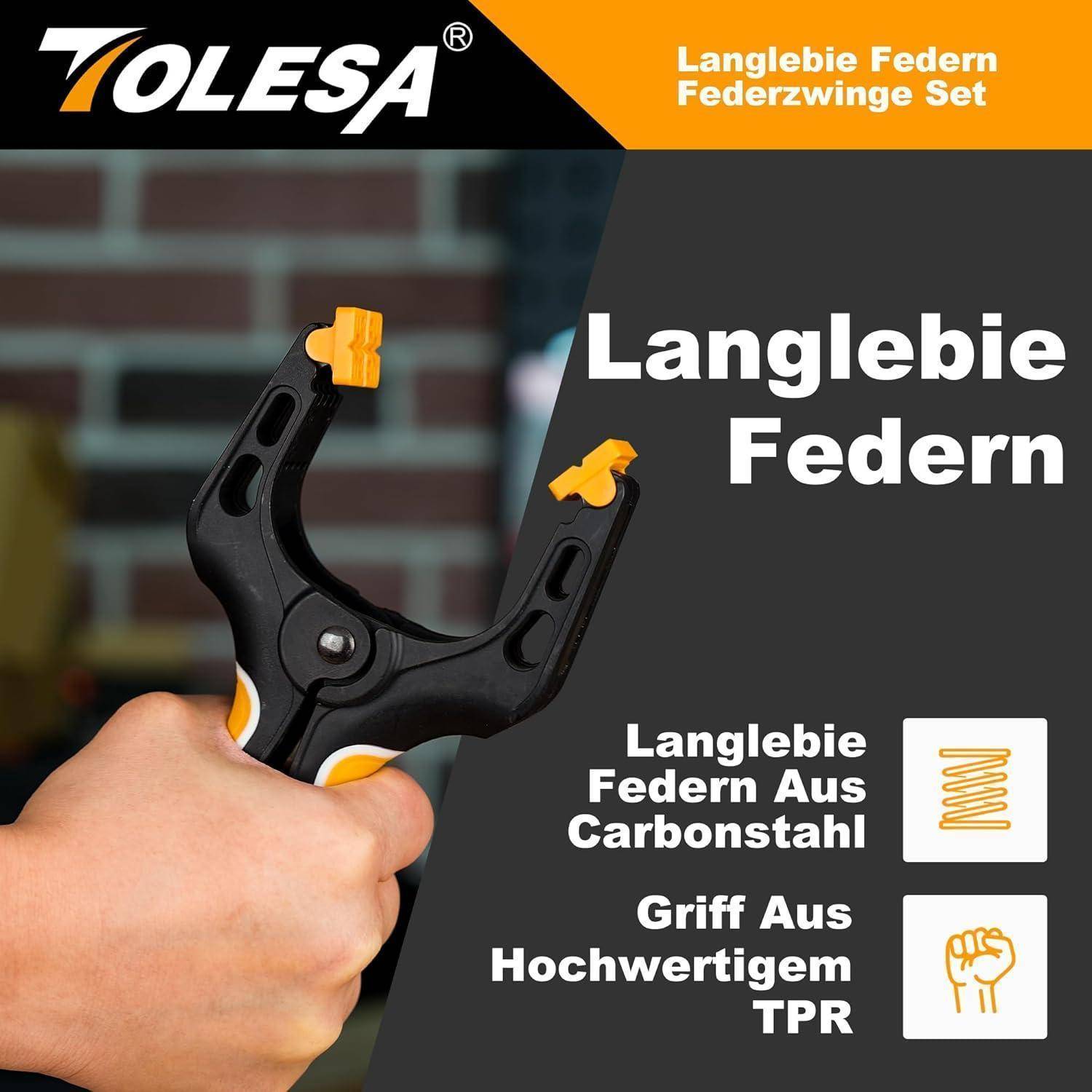 Eine Hand hält eine schwarze Klemme mit orangefarbenen Akzenten. Der Text lautet 
