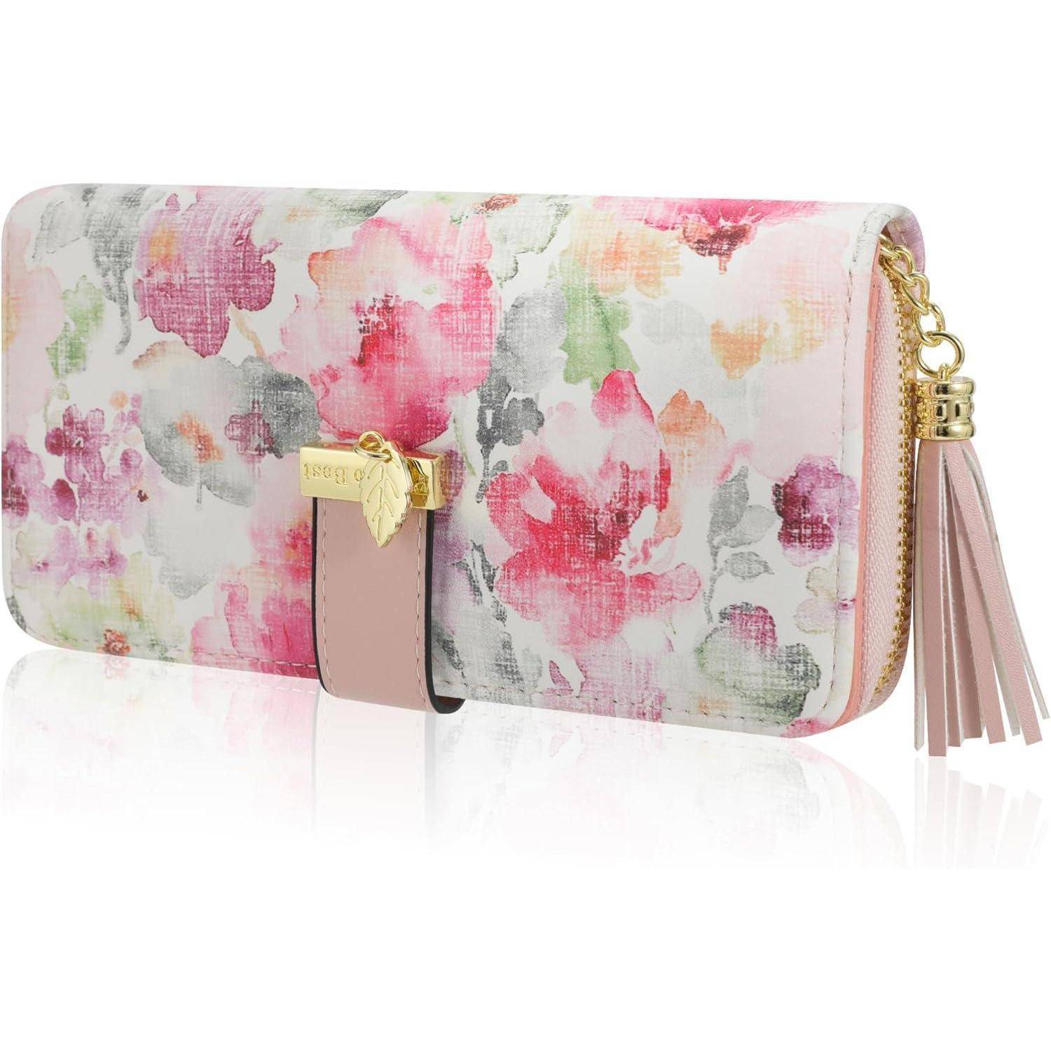 Brieftasche mit Blumenmuster in rosa Tönen, goldener Reißverschluss und einem Quasten-Schlüsselanhänger.