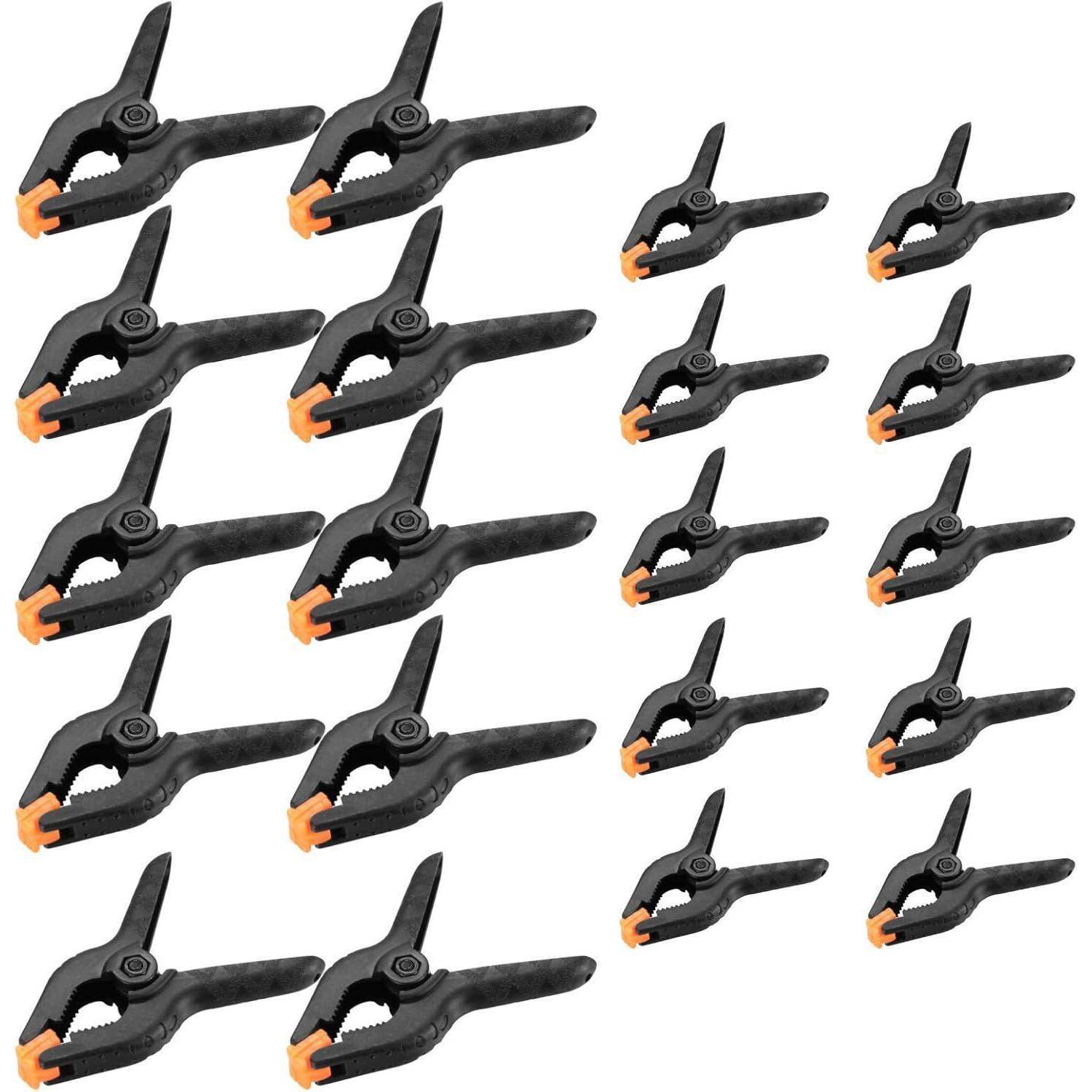 Verschiedene schwarze und orangefarbene Federzangen, in Reihen angeordnet und von größer nach kleiner sortiert.