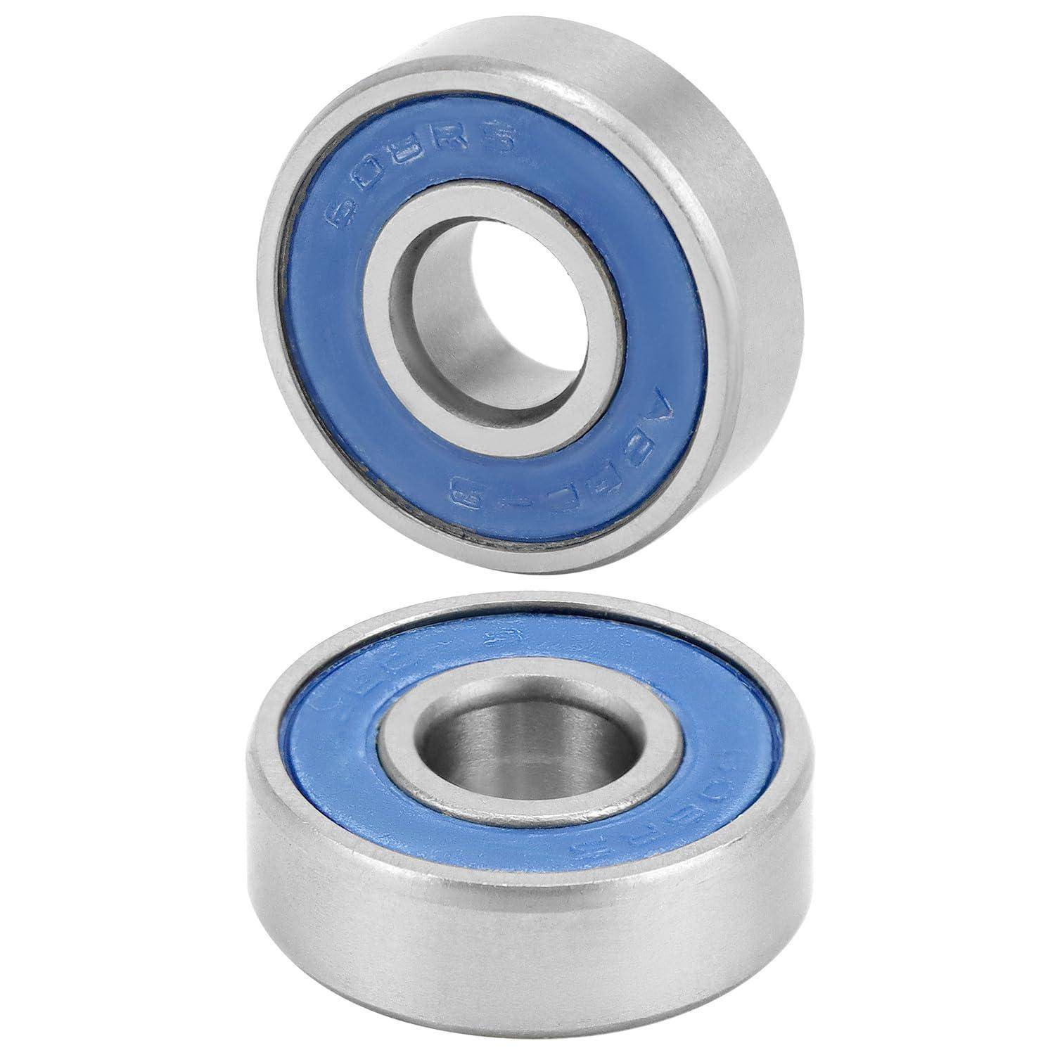 Zwei Metallkugellager mit blauen Dichtungen, eines aufrecht stehend und eines flach liegend.