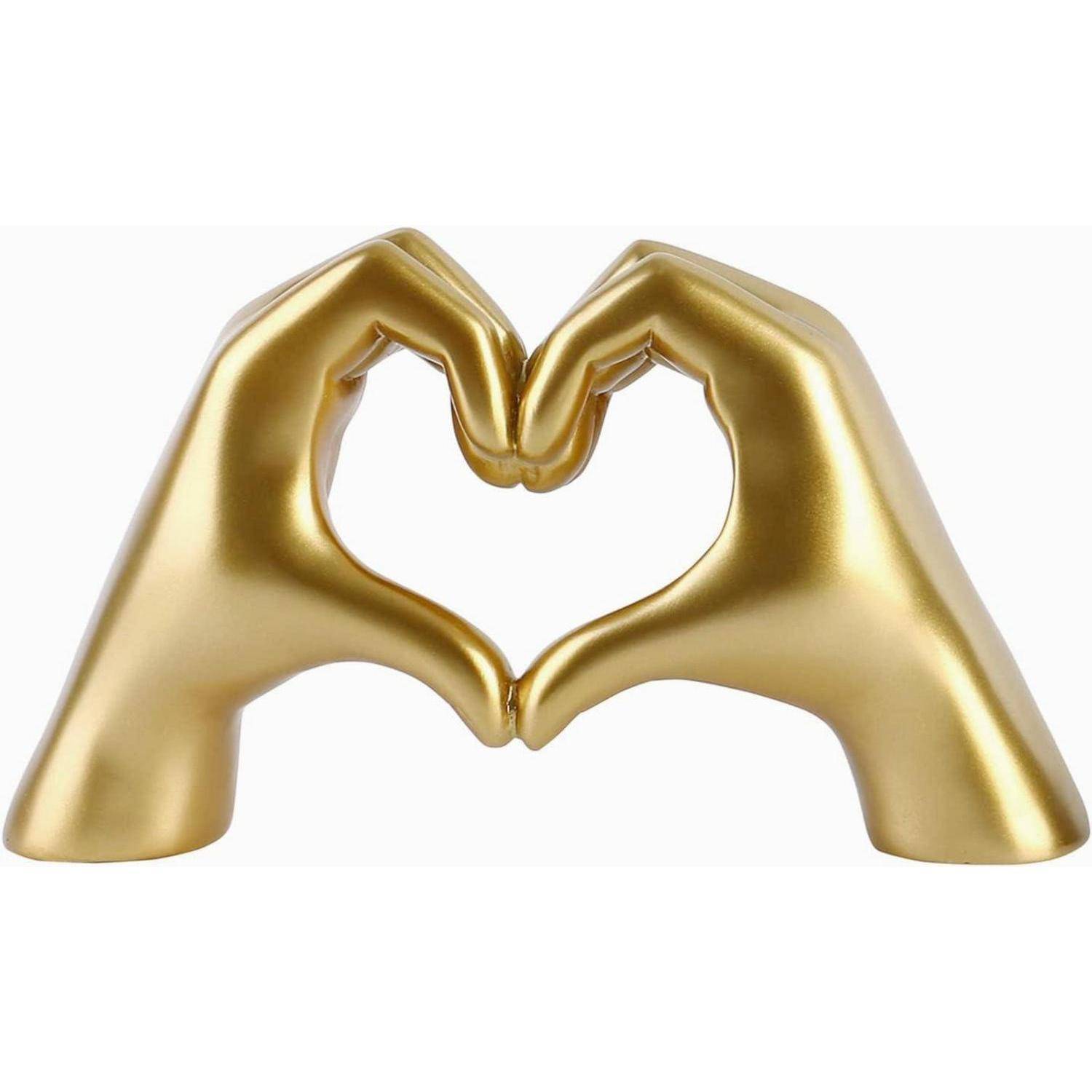 Ein Paar goldener Hände bildet eine Herzform und symbolisiert Liebe und Einheit.