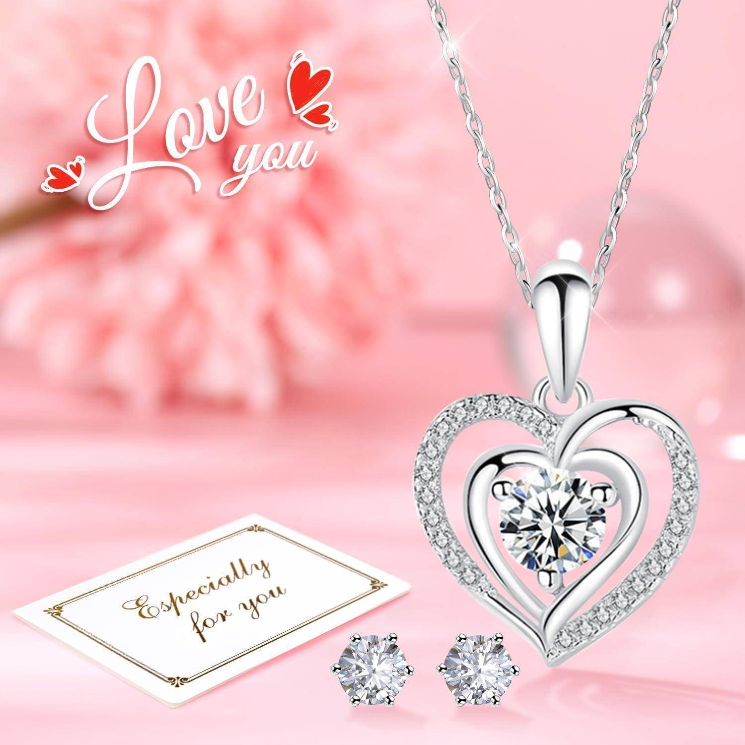 Das Bild zeigt eine herz­förmige Halskette mit einem Diamanten, Diamant­ohrringe und eine Karte mit der Aufschrift „Besonders für dich