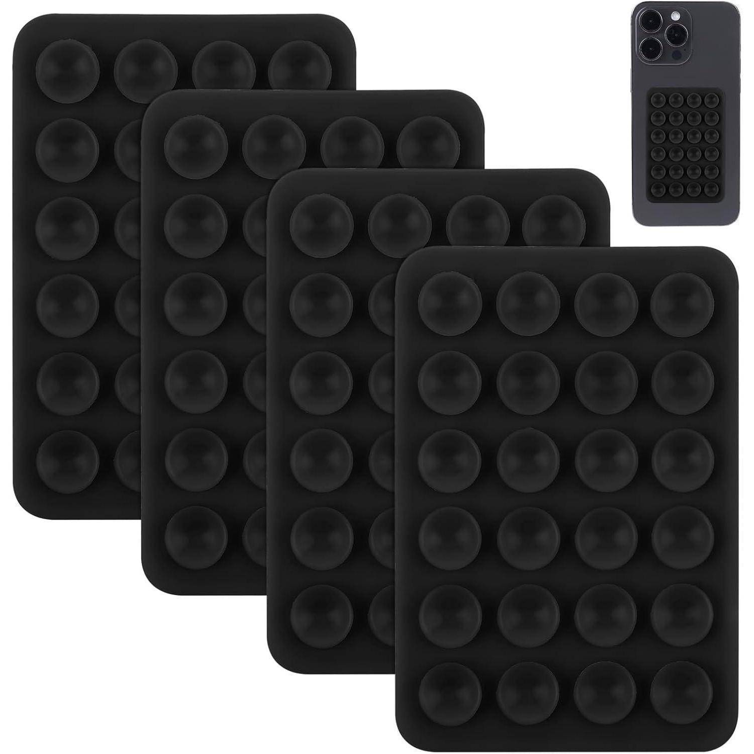 Vier schwarze Silikonpads mit Antirutsch-Funktion und Saugnapf, vertikal angeordnet. Eine Beispielanwendung zeigt ein Smartphone mit einem passenden Pad, das daran befestigt ist.