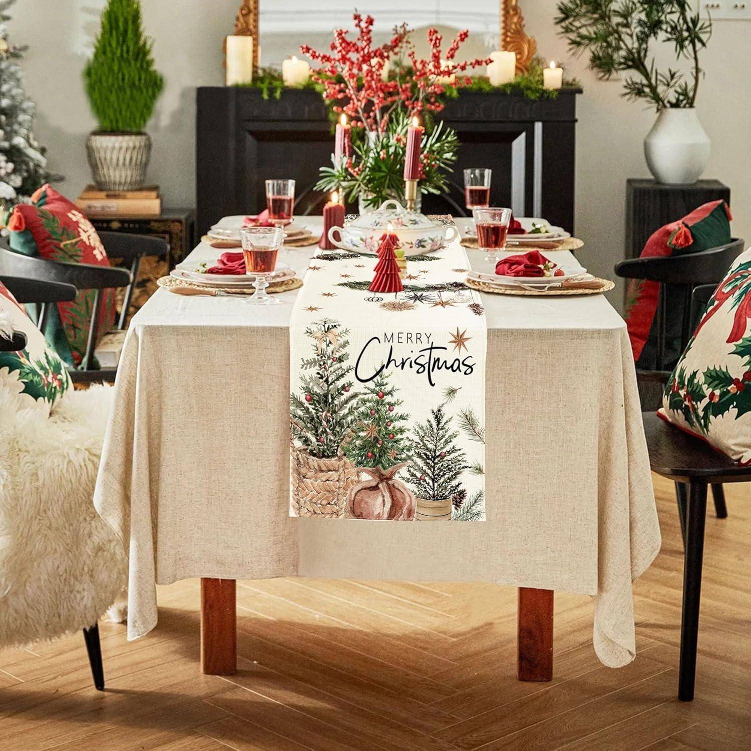Festlich gedeckter Esstisch für Weihnachten mit roten Akzenten, einem Tischläufer mit der Aufschrift „Frohe Weihnachten