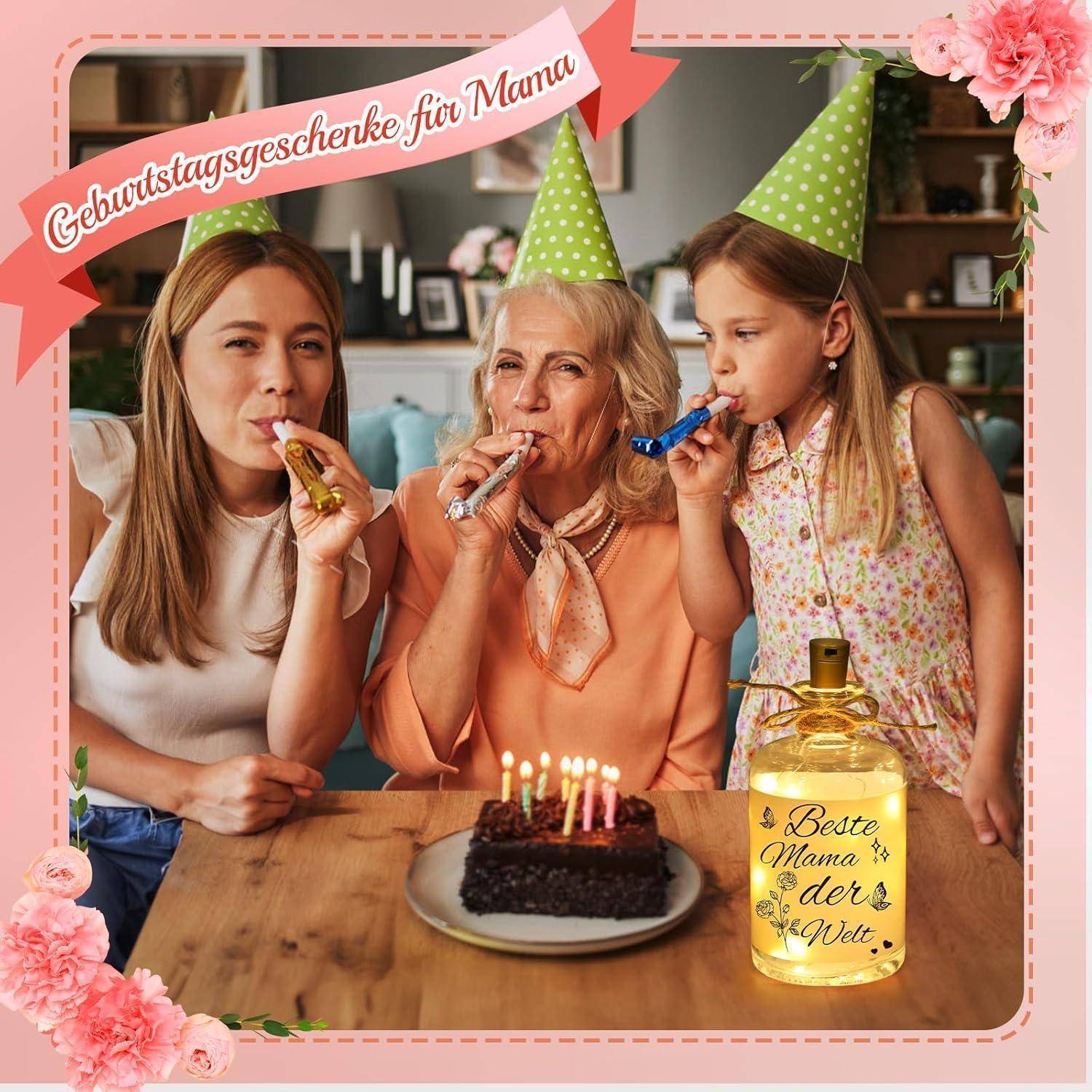 Drei Personen feiern mit Partyhüten und Tröten um eine Torte herum. Eine dekorative Flasche trägt die Aufschrift 