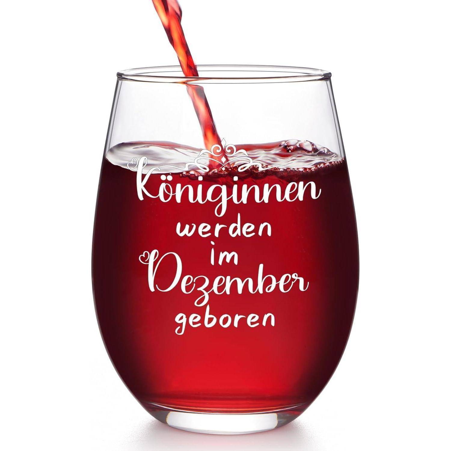 Ein Glas gefüllt mit roter Flüssigkeit, beschriftet mit dem Text ‚Königinnen werden im Dezember geboren'.