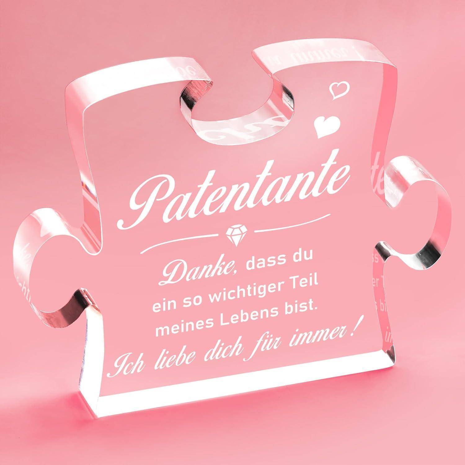 Transparente Puzzleteil mit deutschem Text, das einer Patenmutti dankt, Dankbarkeit und Liebe ausdrückt, vor einem rosa Hintergrund.