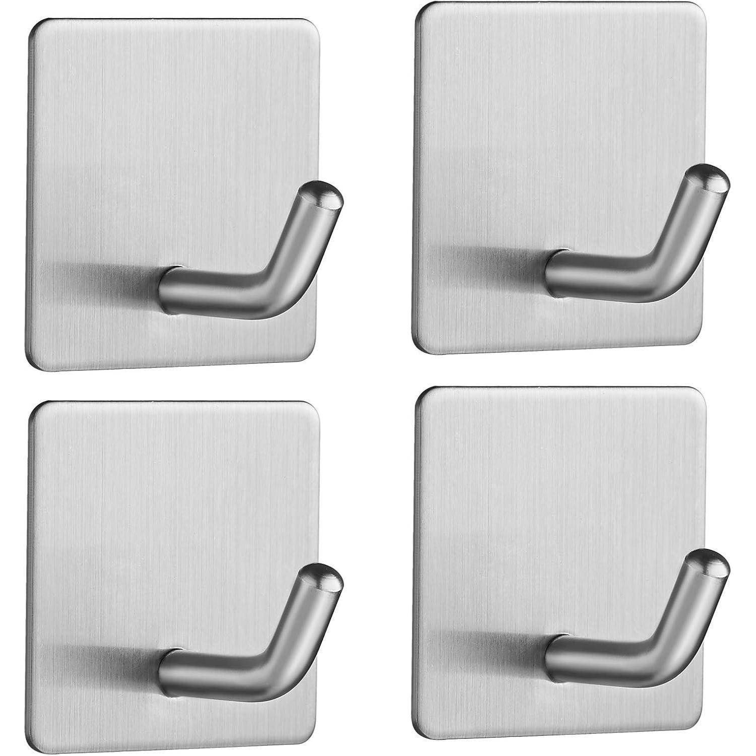 Vier edelstahl-klebehaken, die in einer quadratischen Formation auf einem schlichten Hintergrund angeordnet sind.