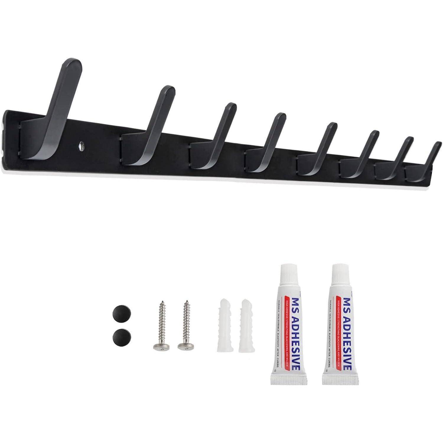 Eine schwarze Wandgarderobe mit acht Haken, inklusive Schrauben, Wanddübeln, zwei Klebetüten und zwei schwarzen Knöpfen.