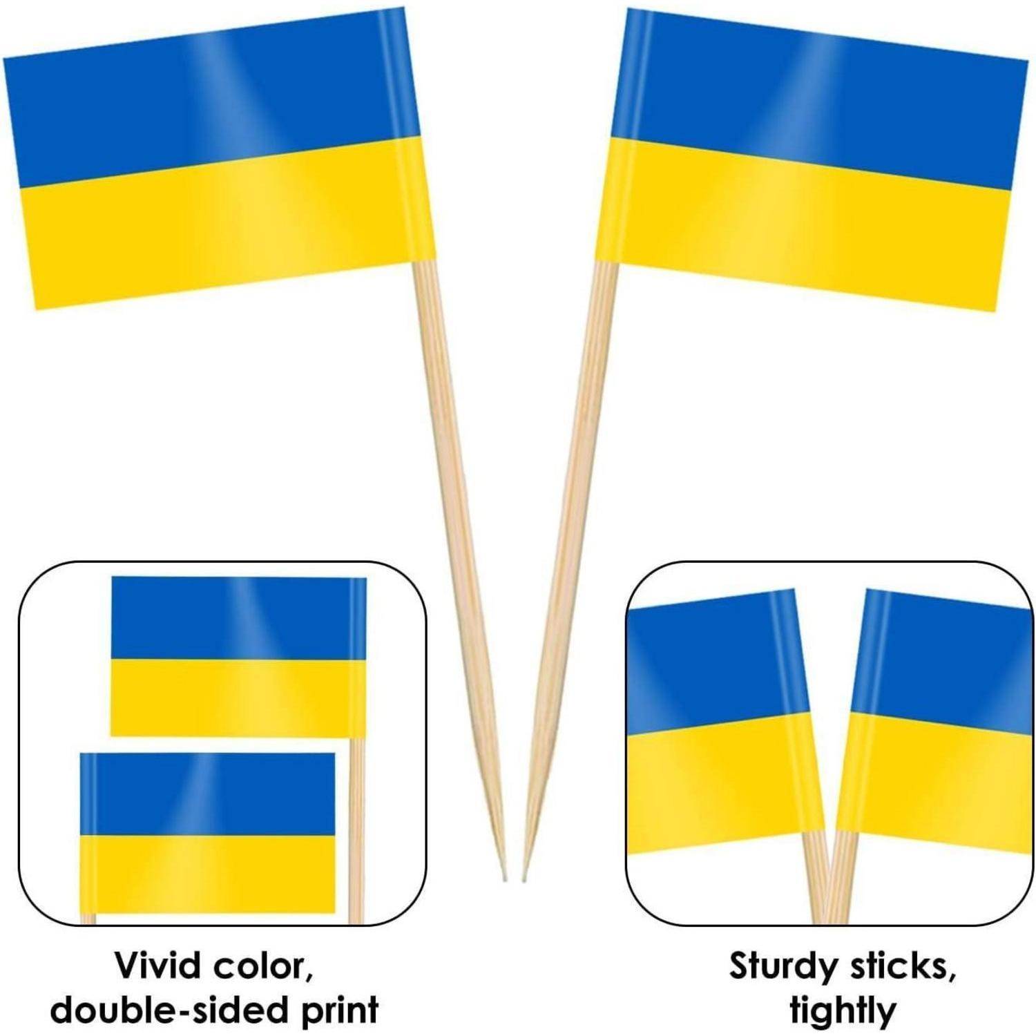 Zwei kleine Ukraine-Flaggen auf Stöcken. Die Flaggen haben blaue und gelbe horizontale Streifen. Text liest sich: 'Lebendige Farbe, beidseitiger Druck' und 'Stabile Stöcke, fest'.