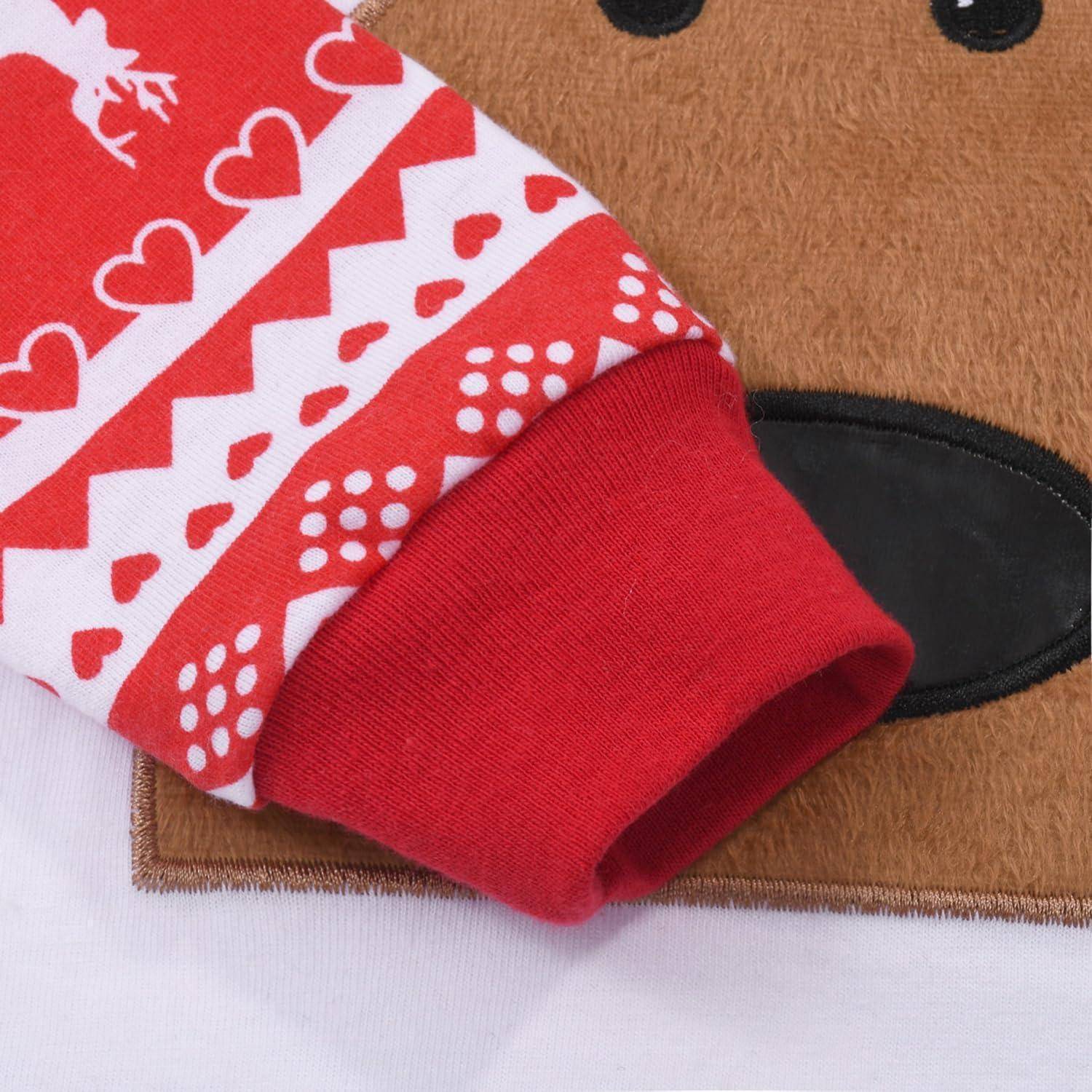 Ein rot-weißer Ärmel mit einem festlichen Muster aus Rentieren, Herzen und geometrischen Formen neben dem Gesicht eines Teddybären auf Stoff.