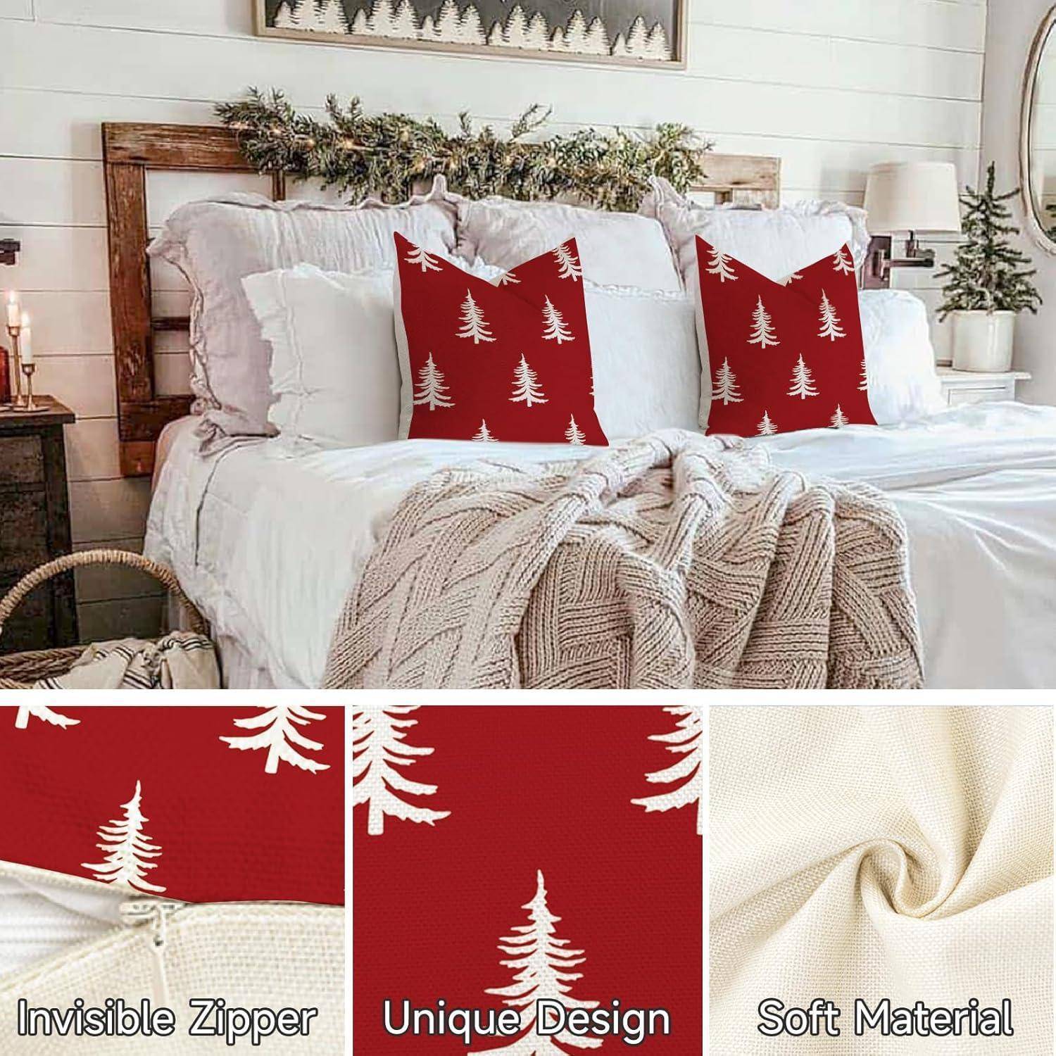 Ein gemütliches Schlafzimmer zeigt ein Bett mit weißen Kissen und zwei roten Kissen mit weißen Baumdesigns. Das Bett ist mit einer gestrickten Decke geschmückt.