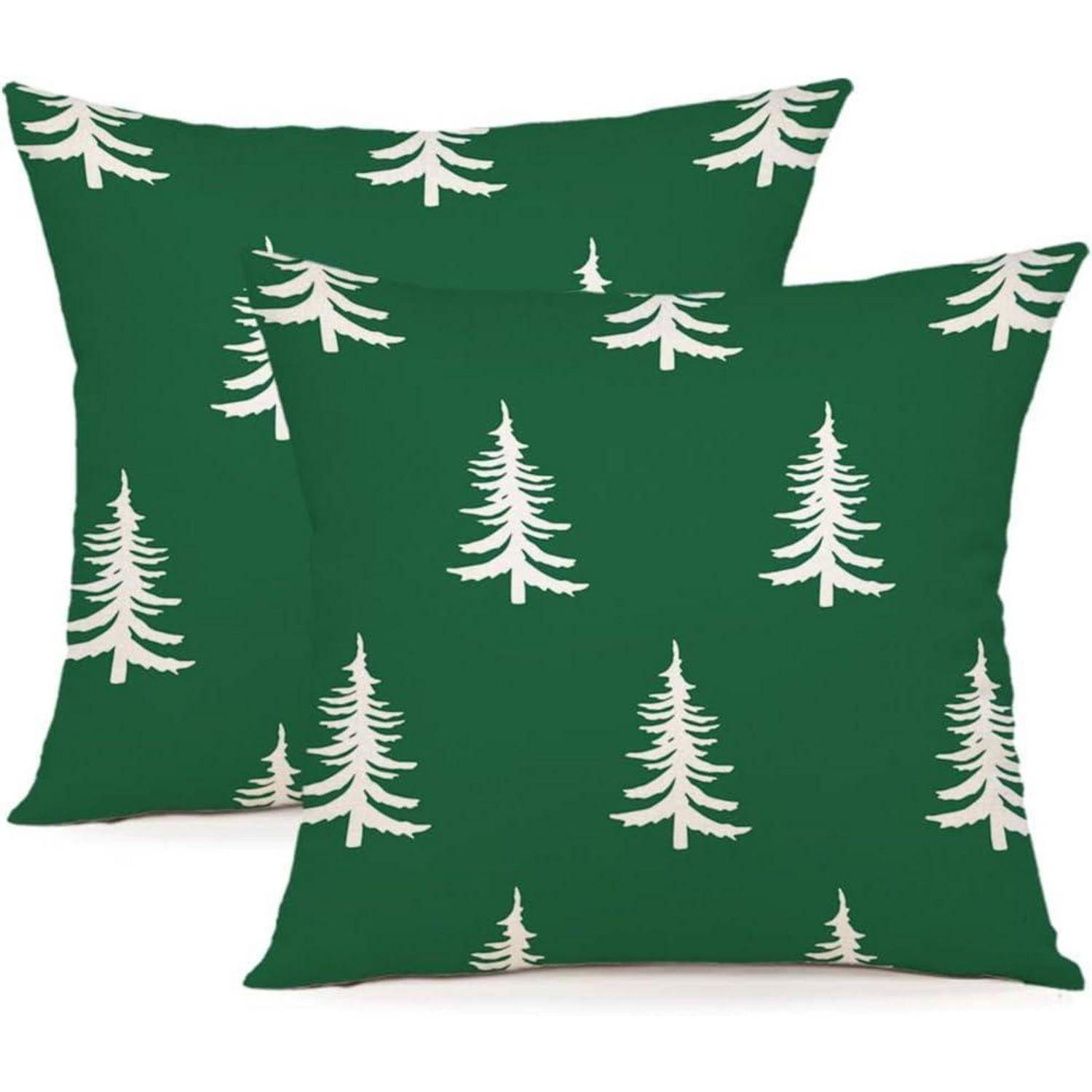 Zwei grüne Kissen zeigen ein sich wiederholendes Muster von weißen Kiefern und schaffen so ein schlichtes, naturinspiriertes Design.