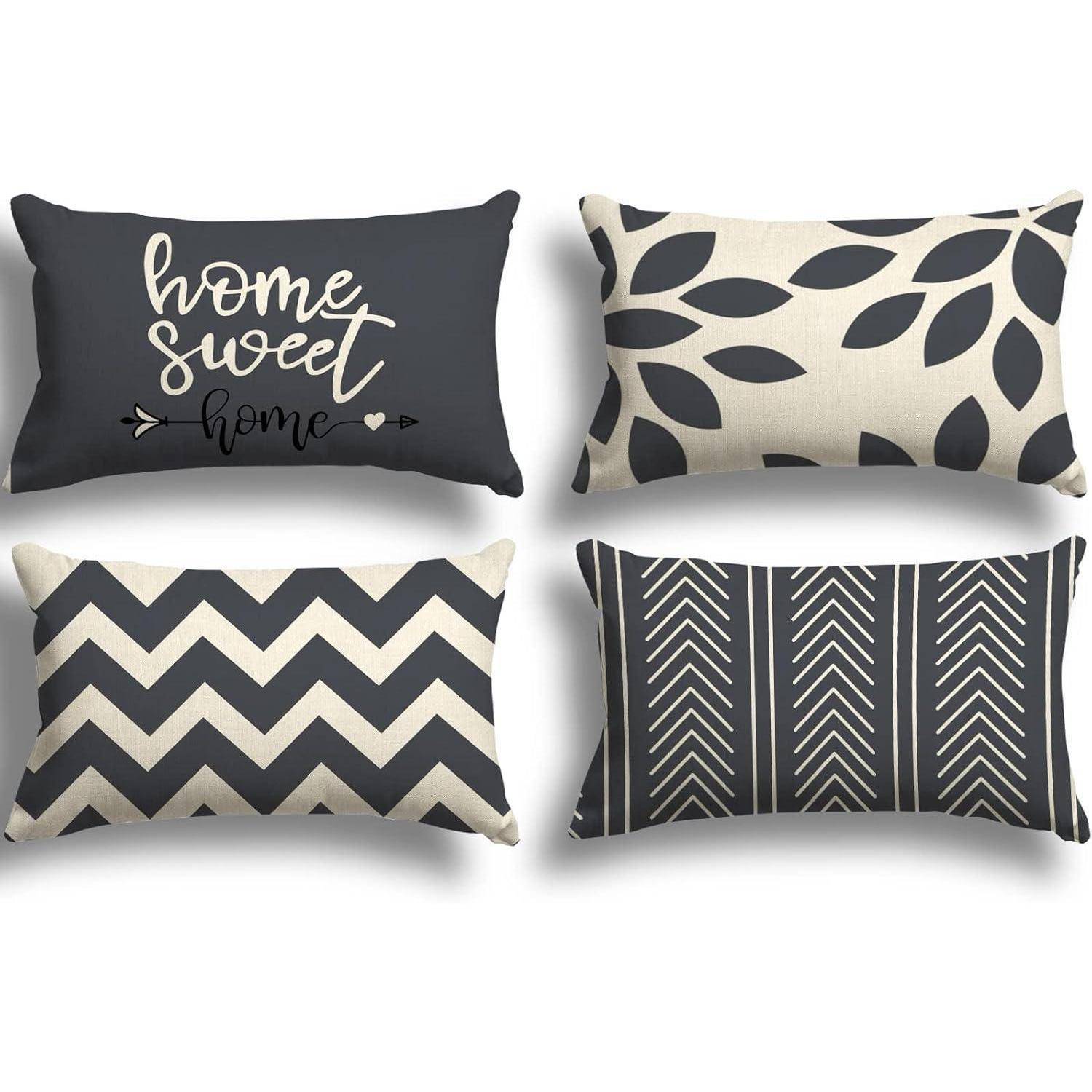 Vier dekorative Kissen mit verschiedenen Mustern: 'home sweet home' Text, Blattmuster, Zickzack-Streifen und Pfeildesign.