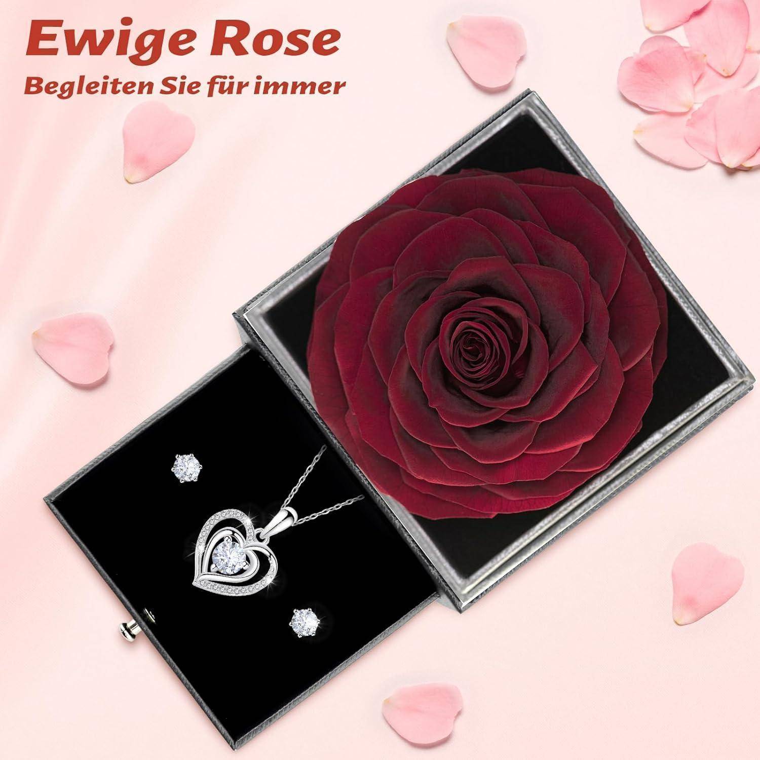 Eine rote Rose, die in einer schwarzen Box konserviert ist, mit einer Schmuckschatulle, die eine herzförmige Halskette und Ohrringe auf der linken Seite enthält. Deutscher Text liest sich: 