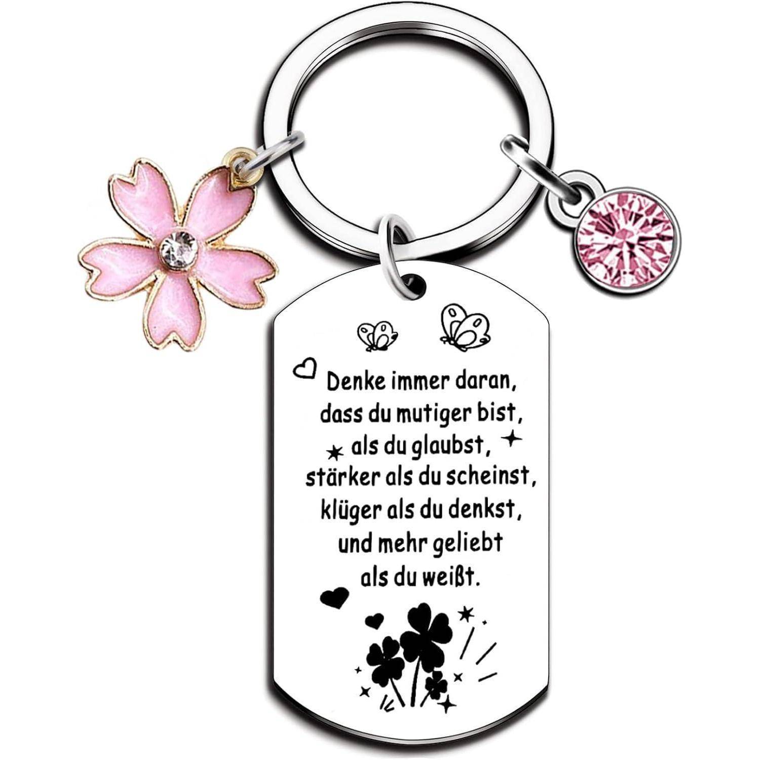 Schlüsselanhänger mit Blumenanhänger und eingravierter Botschaft auf Deutsch, geziert von Schmetterlingen und floralen Mustern.
