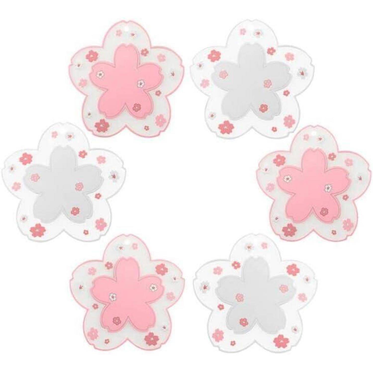 Sechs blumenförmige Objekte in einer kreisförmigen Anordnung, mit abwechselnd rosa und grauen Blütenblättern und kleinen dekorativen Blumen auf jedem Blütenblatt.