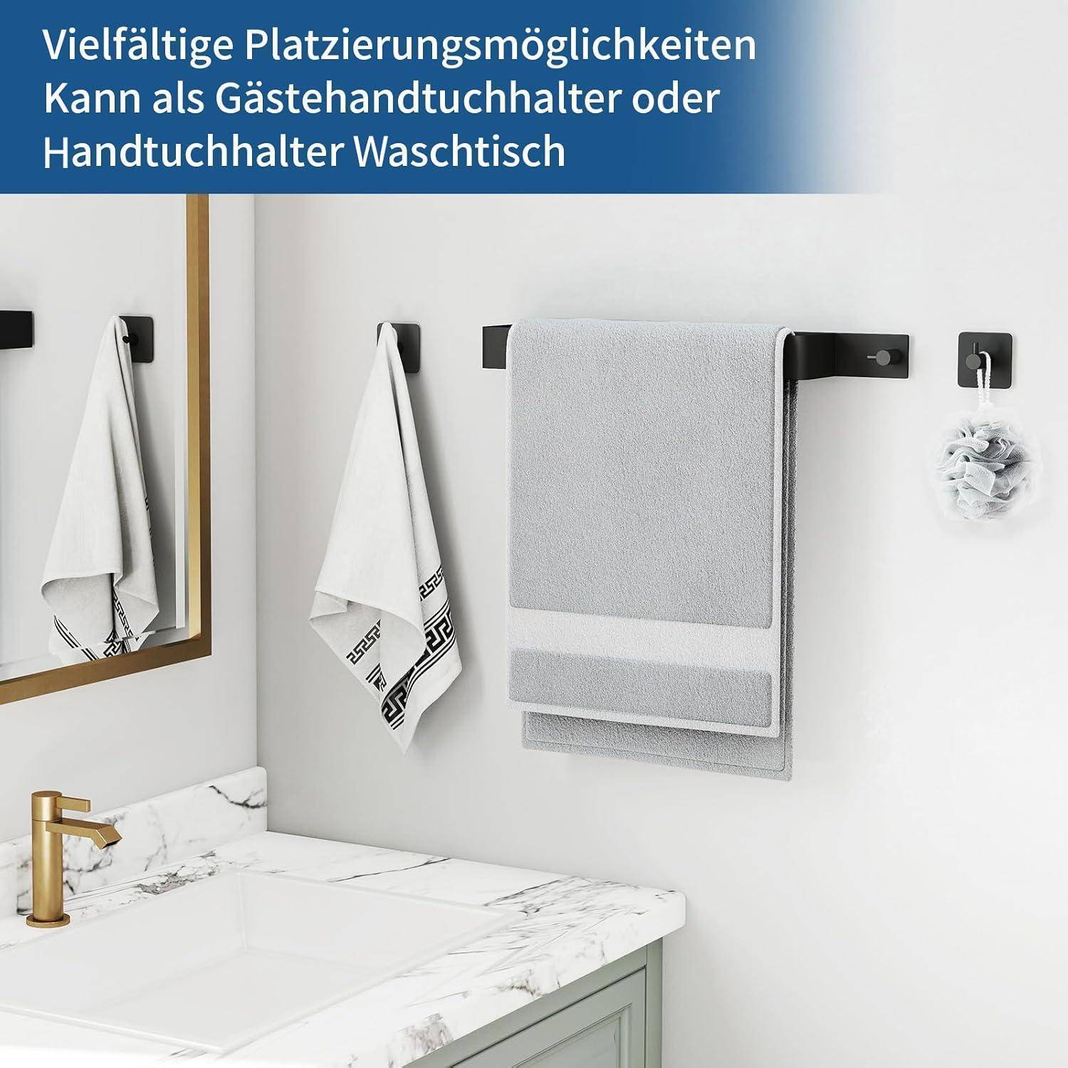 Ein Badezimmer mit einer Marmorplatte, braunem Spiegel und einem Handtuchhalter an der Wand. Ein graues Handtuch hängt am Halter, mit einem kleinen Handtuch darunter.