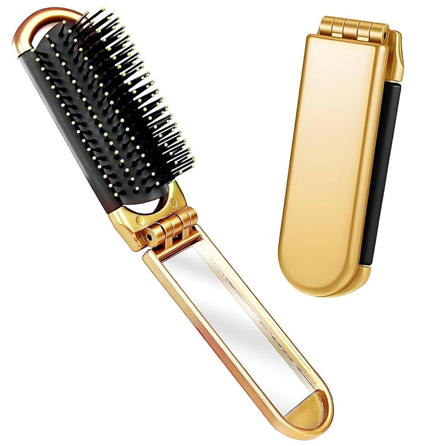 Eine goldene Klapp-Haarbrürste mit einem Spiegelgriff, halb aufgeklappt, um schwarze Borsten mit weißen Spitzen zu zeigen, neben ihrer geschlossenen Form.