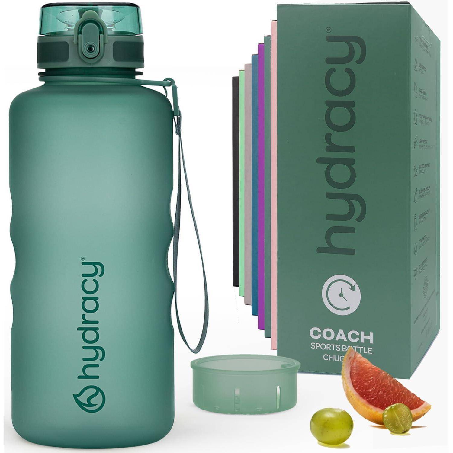 Grüne Hydracy Sporttrinkflasche mit Zeitmarkierungen, abnehmbarem Deckel und Fruchtinfuser. Verpackung zeigt Produktfarben mit Grapefruit und Traube.