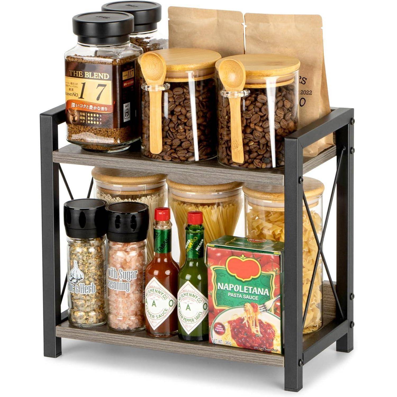 Ein zweistufiges Küchenregal, das Gläser mit Gewürzen, Nudeln, Kaffee und Sauce ordentlich angeordnet für eine organisierte Aufbewahrung trägt.