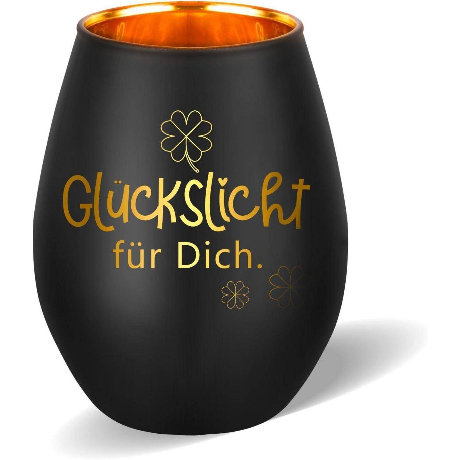 Ein schwarzer Kerzenhalter mit goldener Innenseite, mit dem Text 