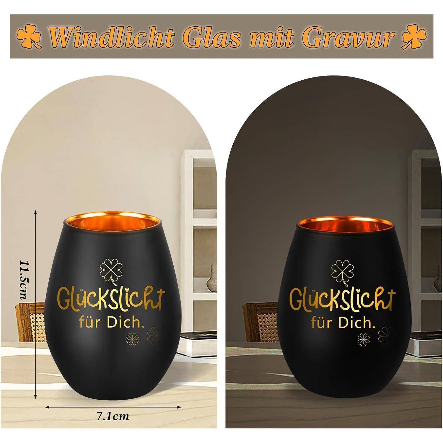 Bild zeigt zwei schwarze Glaskerzenhalter mit goldener Innenseite. Jeder Halter trägt die Aufschrift 'Glückslicht für Dich' mit Blumenmustern. Maße: Höhe 11,5 cm, Durchmesser 7,1 cm.
