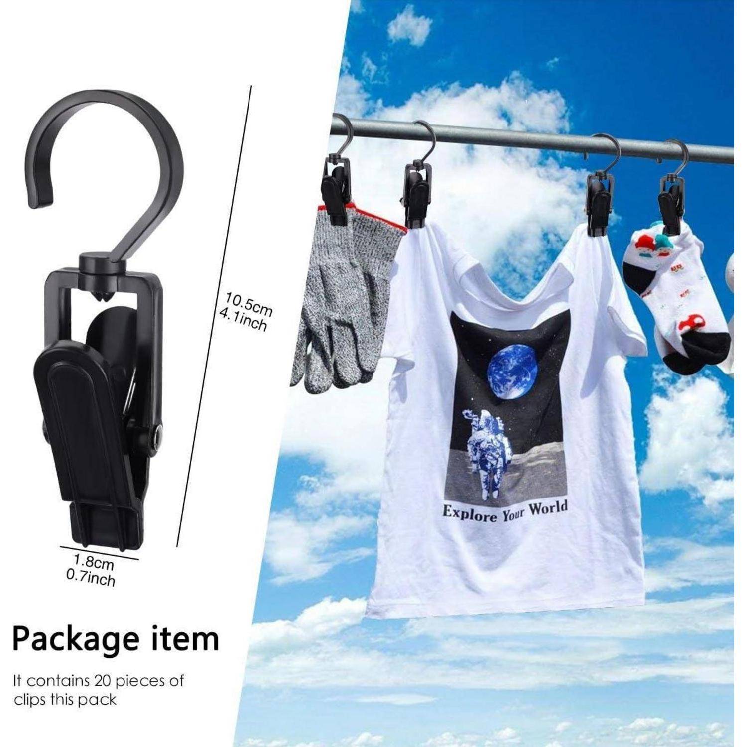 Wäsche trocknet im Freien an einer Stange mit schwarzen Klammern. Ein T-Shirt mit dem Aufdruck „Explore Your World
