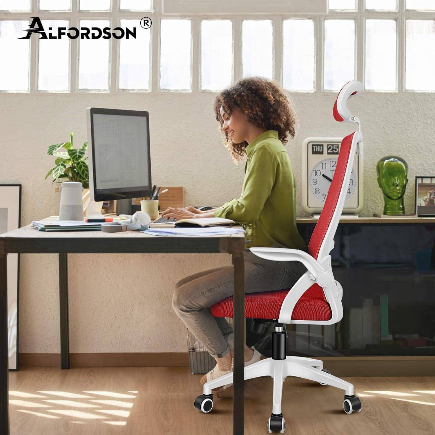 Eine Person sitzt an einem Schreibtisch und arbeitet an einem Computer in einem Heimarbeitsplatz. Die Umgebung ist hell beleuchtet, mit Pflanzen und einer Kaffeetasse in der Nähe.