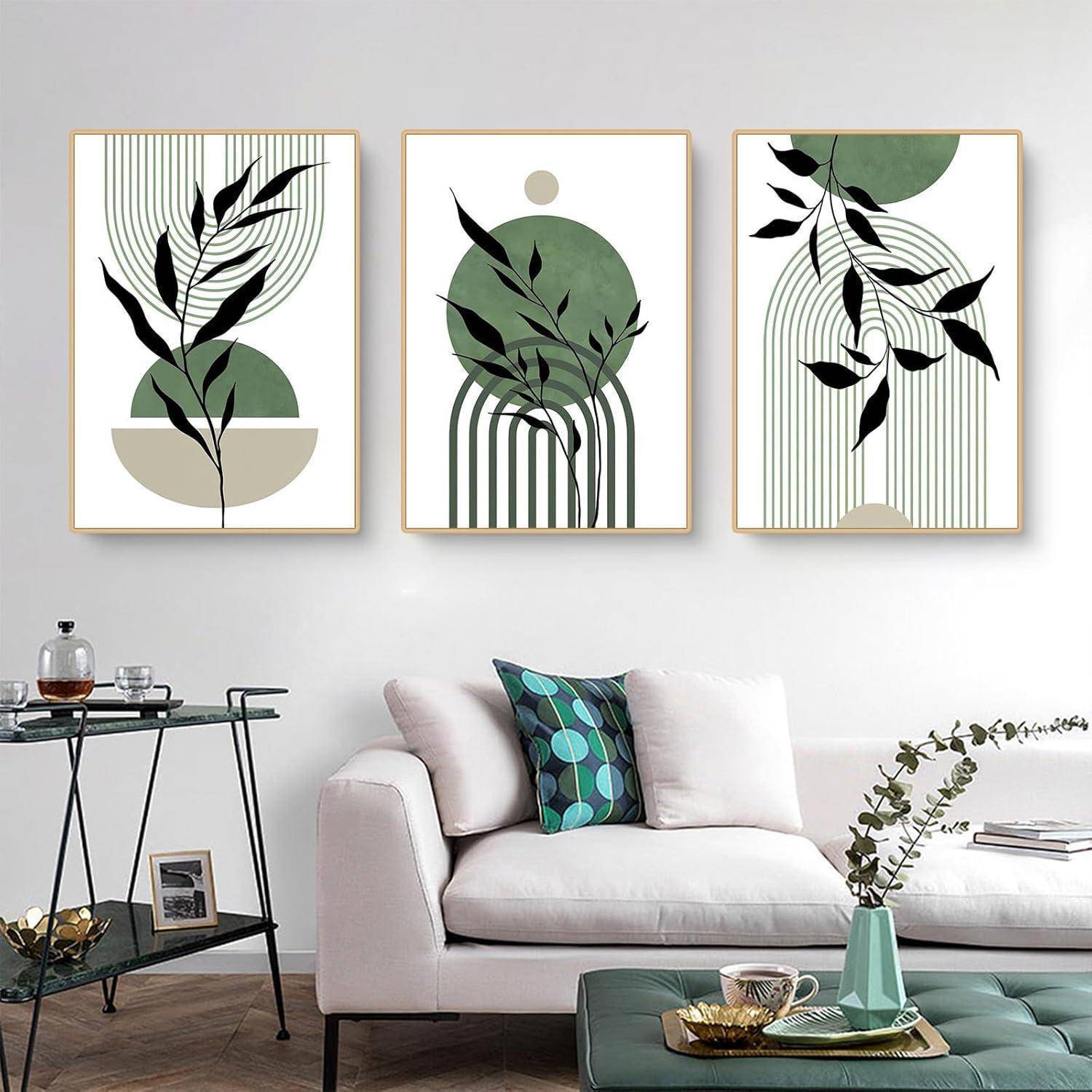 Ein modernes Wohnzimmer mit einem weißen Sofa, das mit grünen und blauen Kissen versehen ist, einem Glaskaffeetisch und drei abstrakten Pflanzenkunstwerken an der Wand.