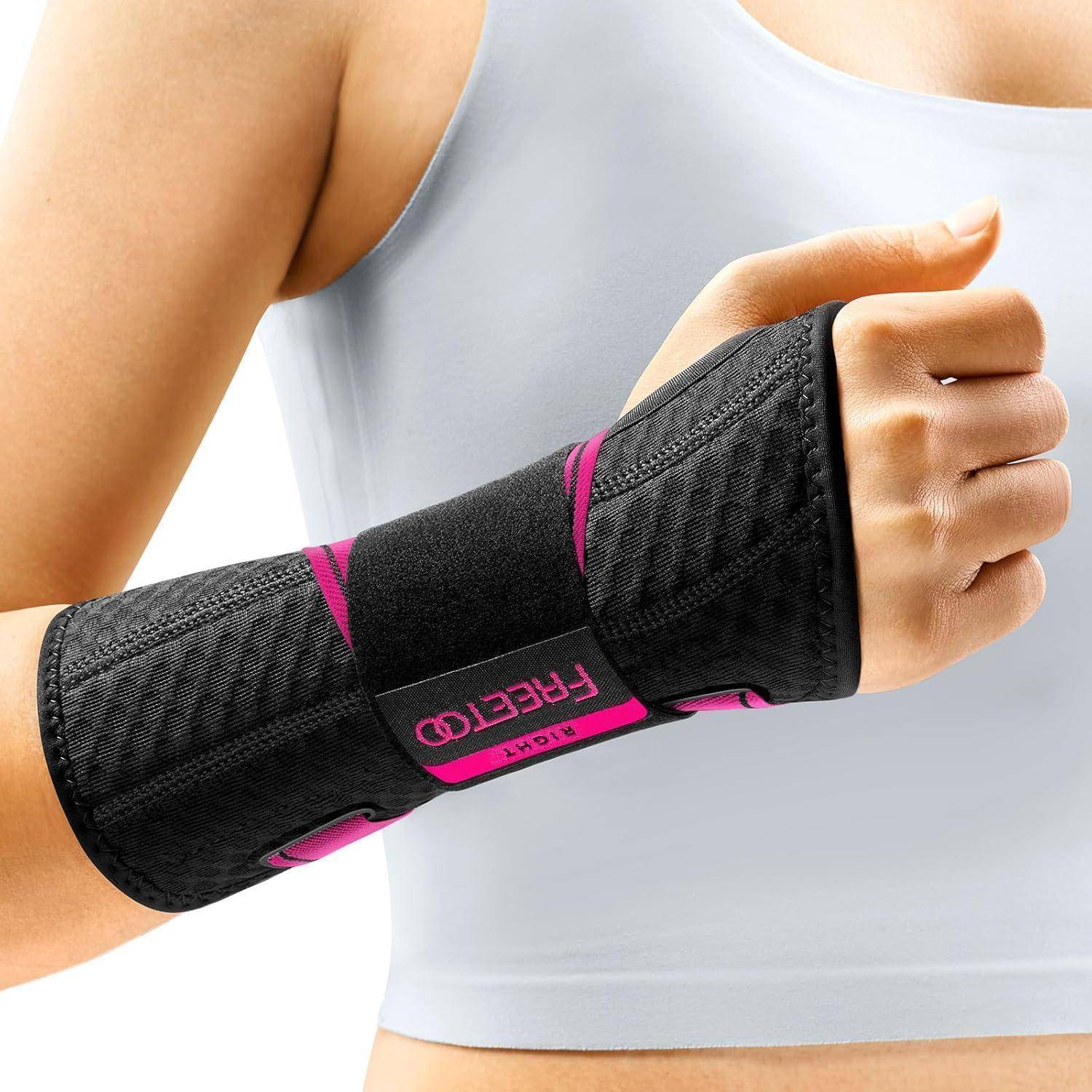 Eine Person, die eine schwarze und rosa Handgelenkbandage am linken Handgelenk trägt, von der Seite gezeigt mit teilweiser Ansicht eines ärmellosen weißen Tops.