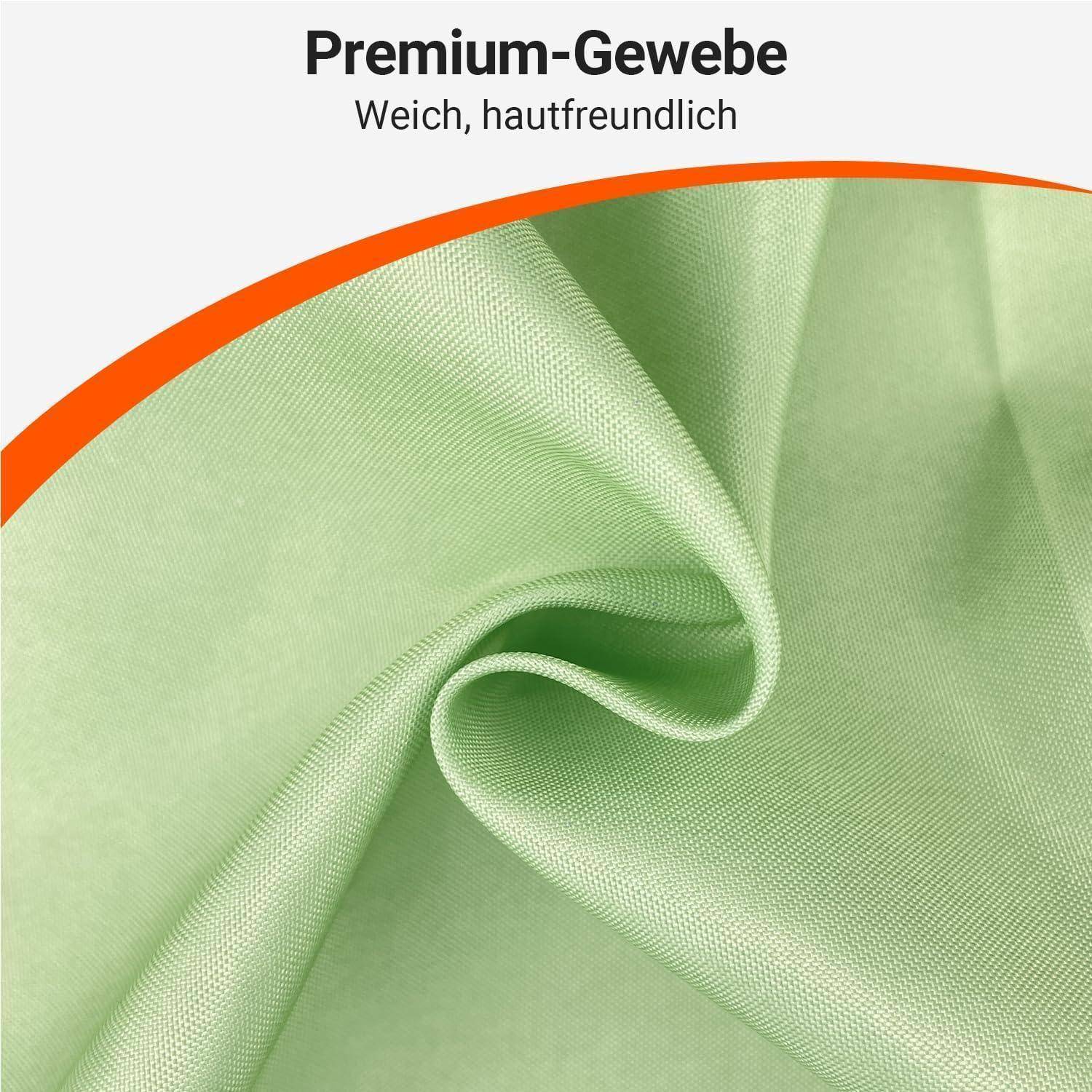 Grüner Premium-Stoff mit glatter Textur, der Weichheit und Hautfreundlichkeit fördert. Orange Bordüre am oberen Rand. Textliche Hervorhebungen unterstreichen die Qualität.