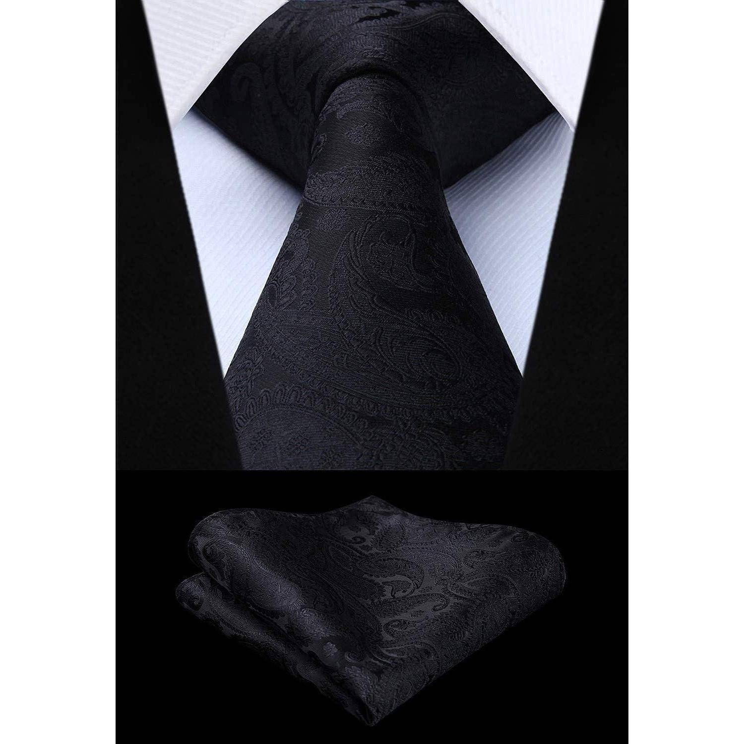 Eine schwarze Paisley-gemusterte Krawatte auf einem weißen Hemd, kombiniert mit einem passenden schwarzen Einstecktuch.