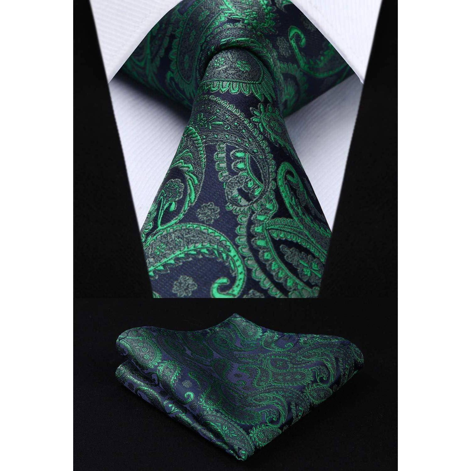 Eine lebendige Paisley-Krawatte und das passende Einstecktuch in Grün und Blau, präsentiert vor einem weißen Hemd und einem dunklen Anzug.