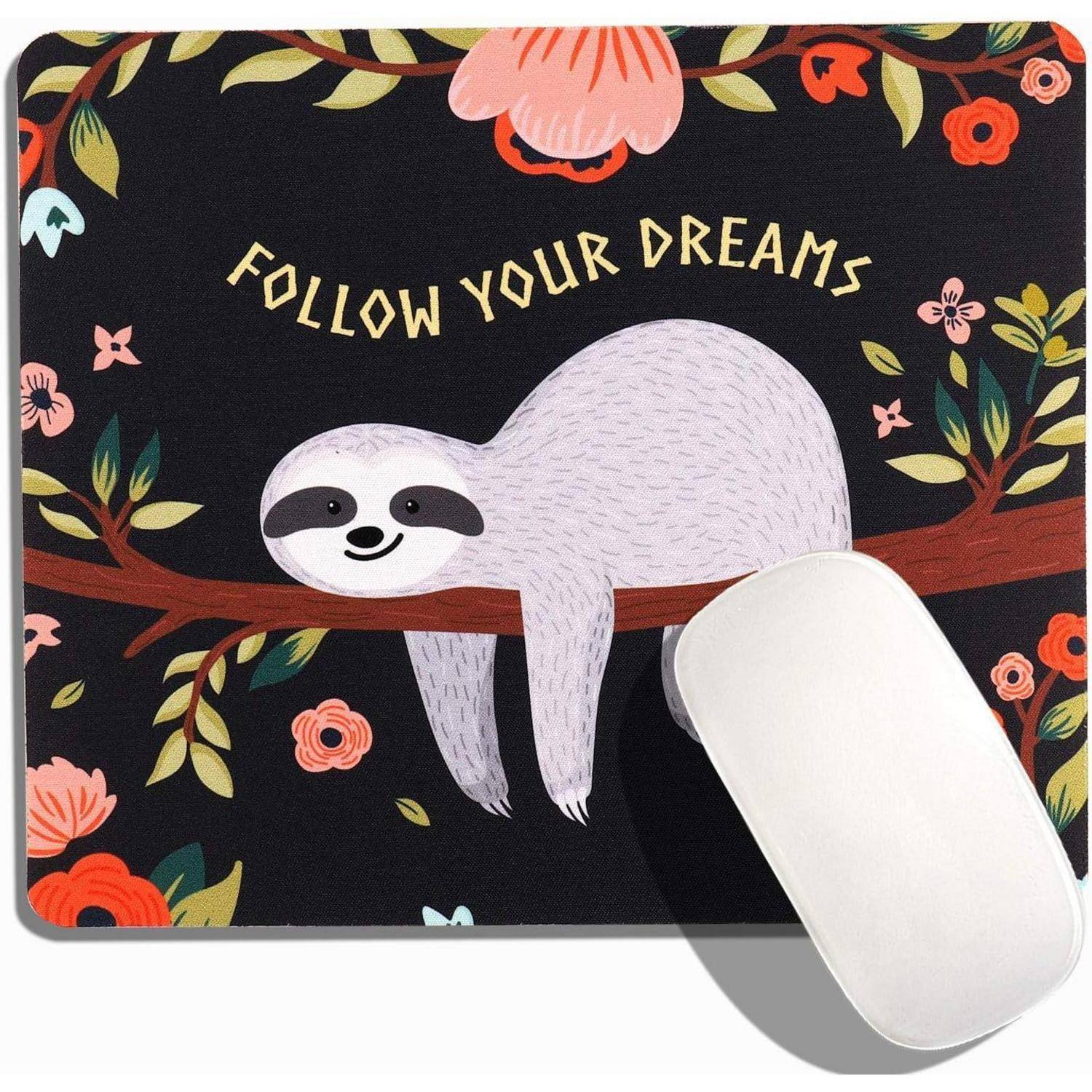 Eine Faultier liegt auf einem Ast, umgeben von bunten Blumen, mit dem Text ‚Folge deinen Träumen' darüber auf einem Mousepad.