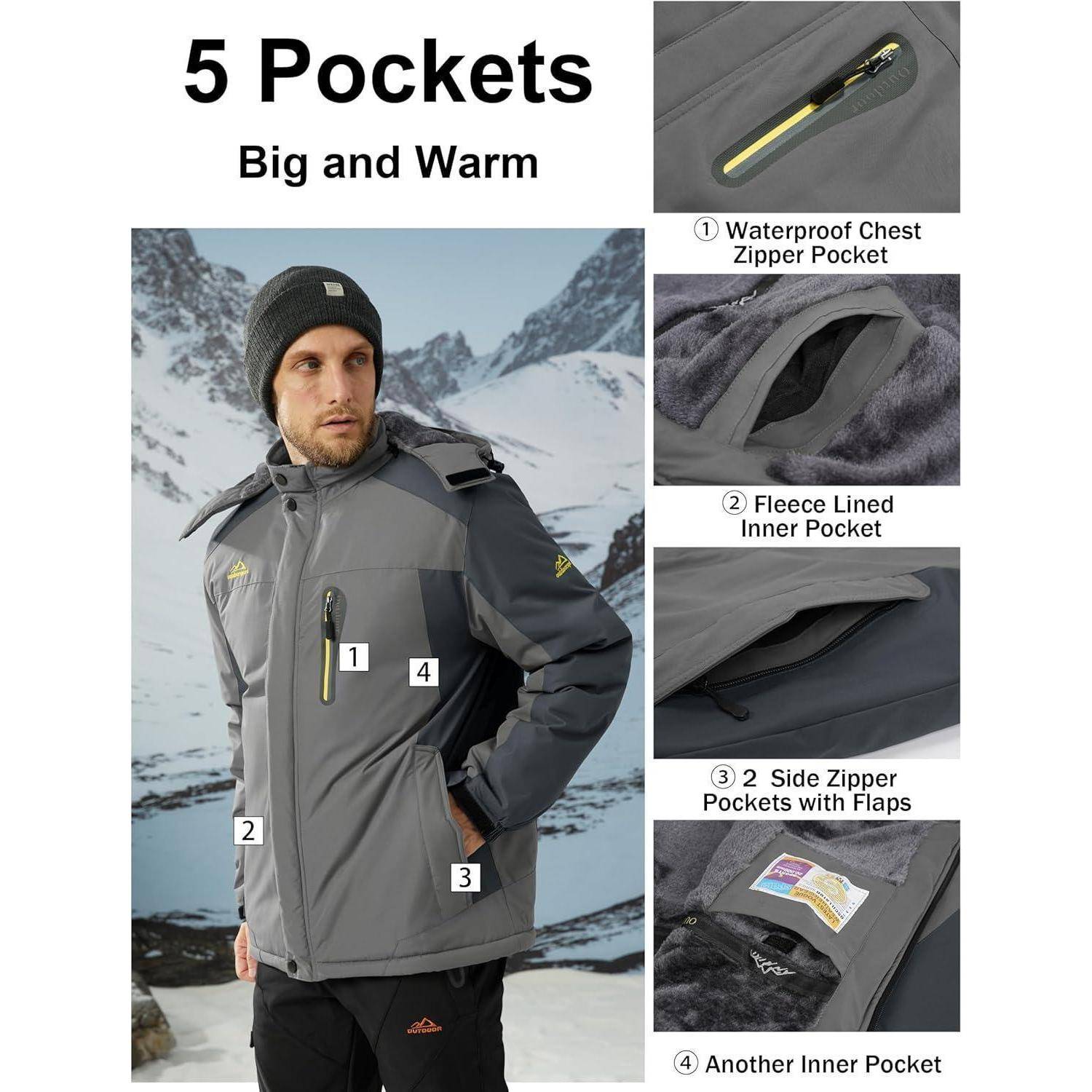Ein Mann steht im Freien in verschneiten Bergen und trägt eine graue Jacke mit der Aufschrift 