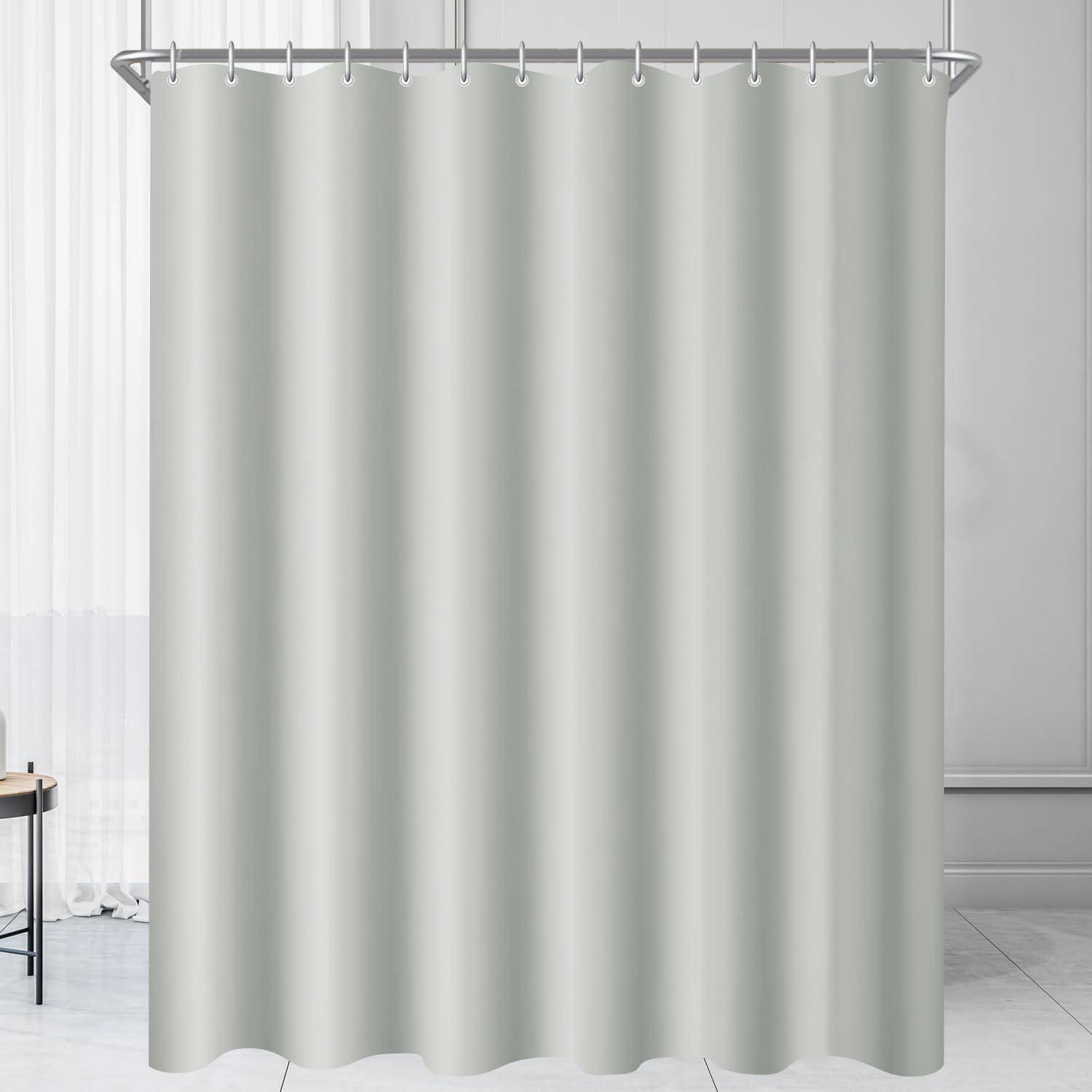 Ein hellgrauer Duschvorhang hängt von Metallhaken in einem Badezimmer mit einer teilweisen Sicht auf ein Fenster und einen Stuhl auf der linken Seite.