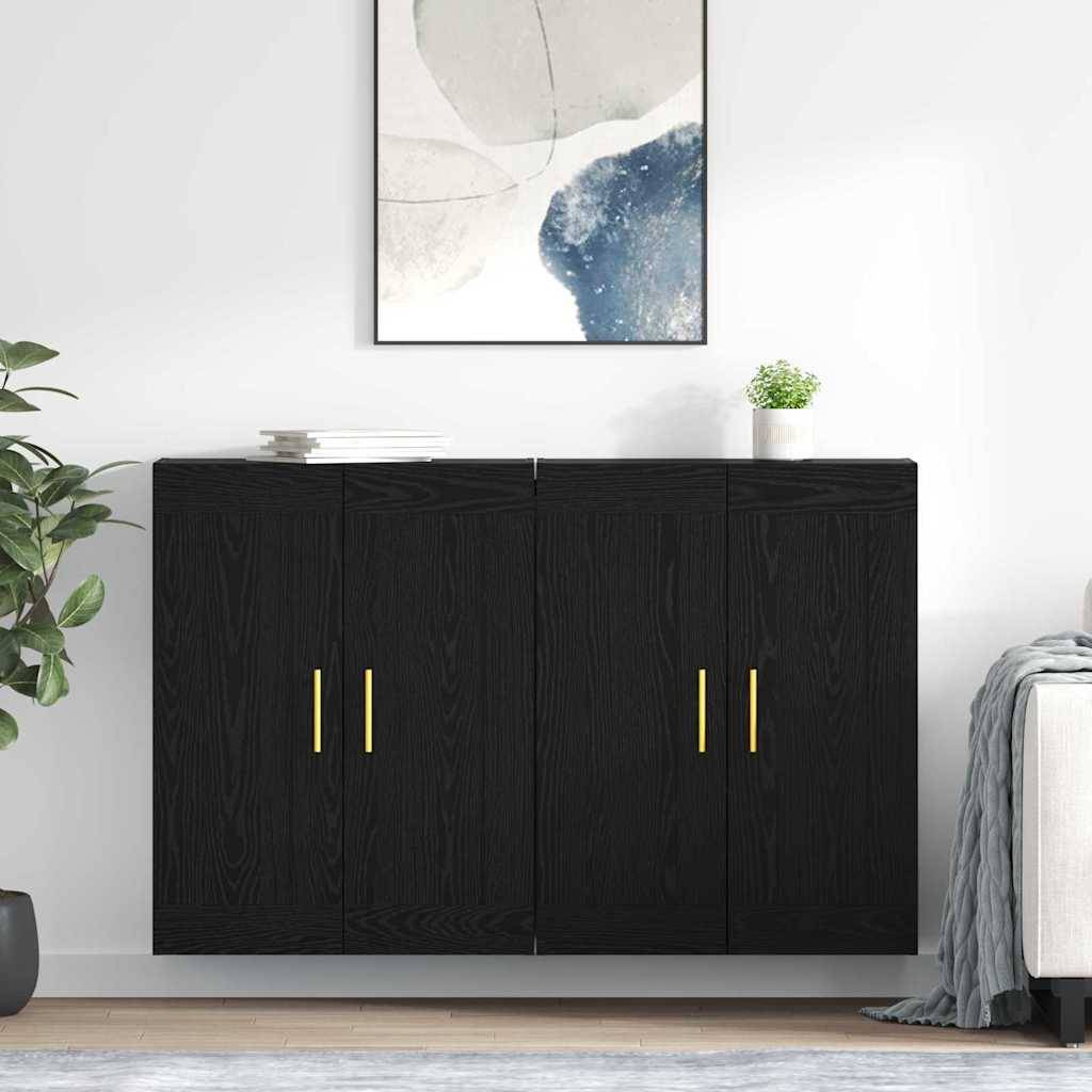 Ein schwarzer Schrank mit goldenen Griffen steht gegen eine weiße Wand. Er ist mit Büchern und einer Pflanze bedeckt, wobei abstrakte Kunst darüber hängt. Eine Pflanze und ein Stuhl flankieren den Schrank.