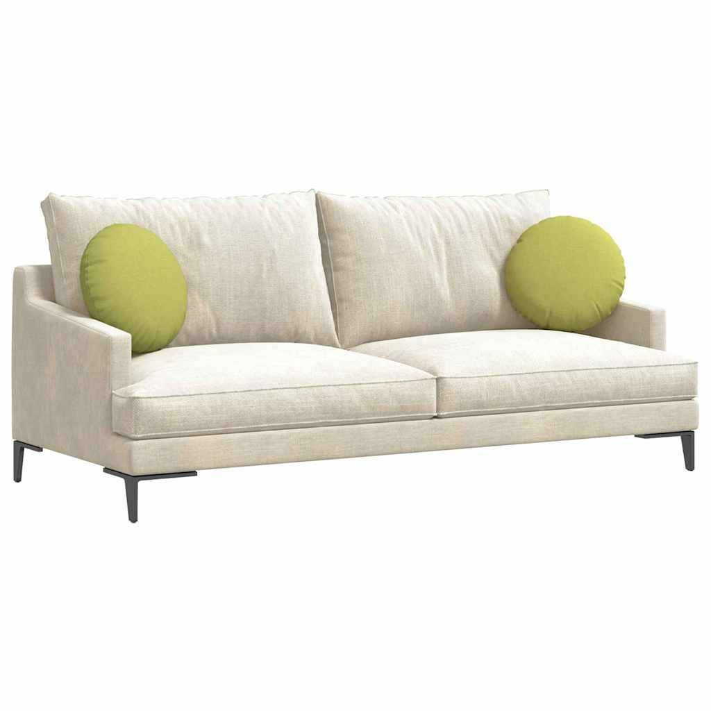 Ein beiger Sofa mit zwei grünen runden Kissen, mit minimalistischem Design und dunklen Holzbeinen, der vor einem schlichten Hintergrund platziert ist.