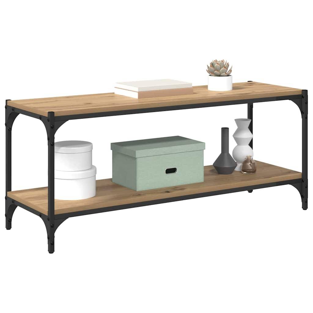 Ein hölzernes zweistufiges Regal mit Metallstützen präsentiert einen Stapel Bücher, eine grüne Schachtel, zwei weiße Behälter, eine graue Vase und eine kleine Pflanze.