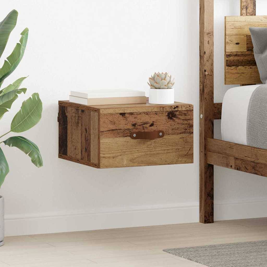 Schwimmender Nachttisch aus Holz mit Schublade und Topfpflanze oben; neben einem rustikalen Holzbettgestell an einer weißen Wand.