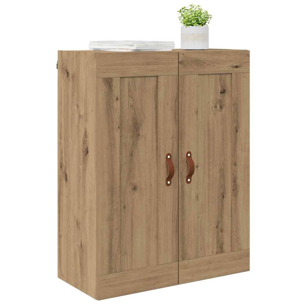 Ein Holzschrank mit zwei Türen, die mit Ledergriffen versehen sind. Eine Topfpflanze und ein Stapel Teller befinden sich oben darauf.
