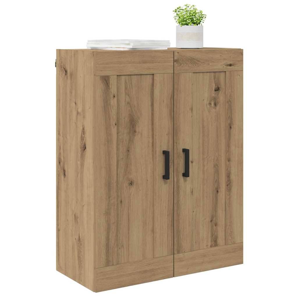 Ein Holzschrank mit zwei Türen, schwarzen Griffen, einer Topfpflanze und gestapelten Tellern oben drauf.