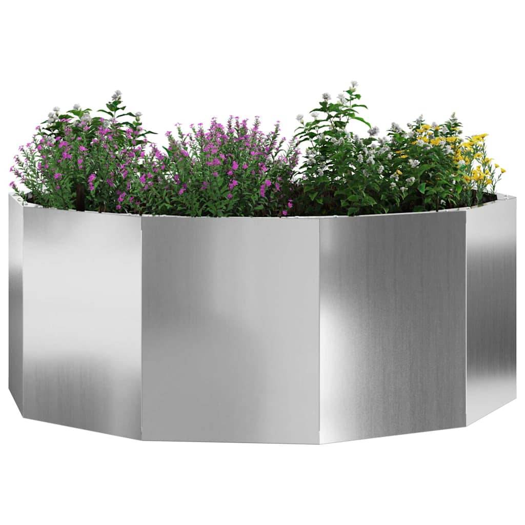 Ein sechseckiger Edelstahlblumentopf, gefüllt mit verschiedenen Arten von kleinen, lebhaften Blumen, darunter rosa und gelbe Blüten.