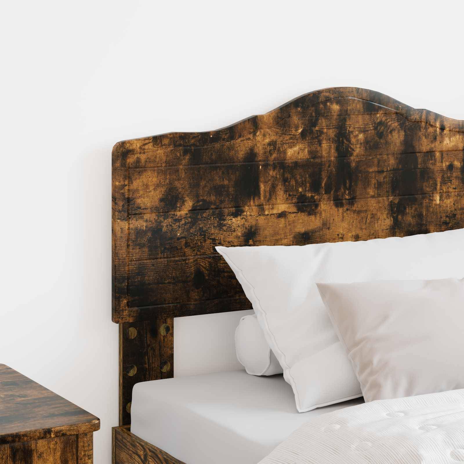 Ein Bett mit einem rustikalen Holzkopfteil, weißer Bettwäsche und Kissen, teilweise neben einem Holznachttisch sichtbar, in einem minimalistischen Schlafzimmer.